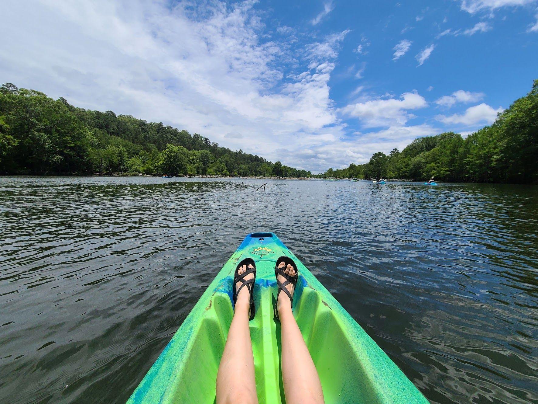 Looking at Lydia's feet on the kayak in the Mountain Fork River.