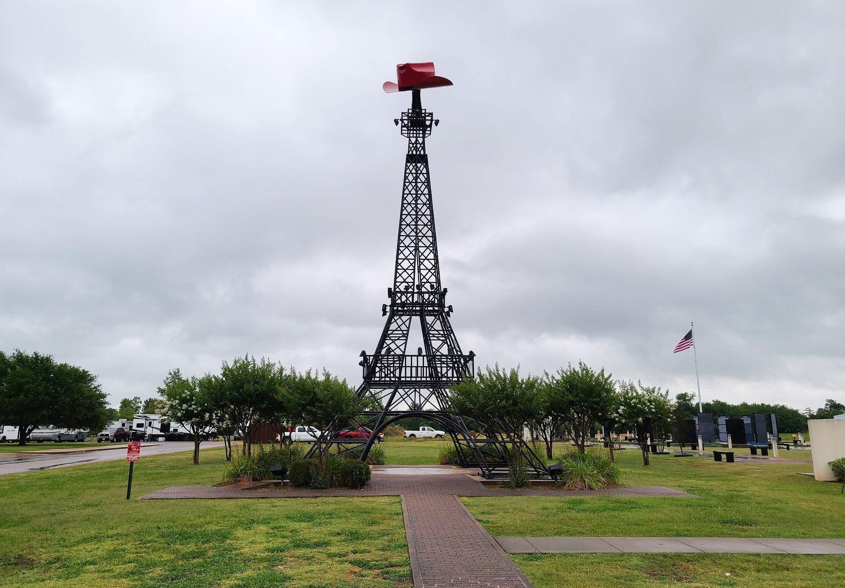 An eiffel tower with a red cowboy hat on top in Paris, Texas.