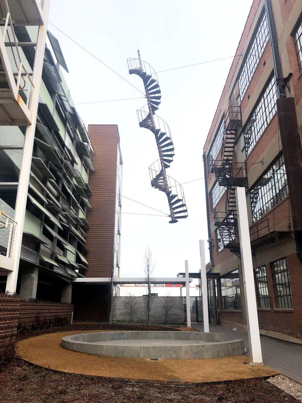 An alley with a hanging spiral staircase that resembled a DNA strand.