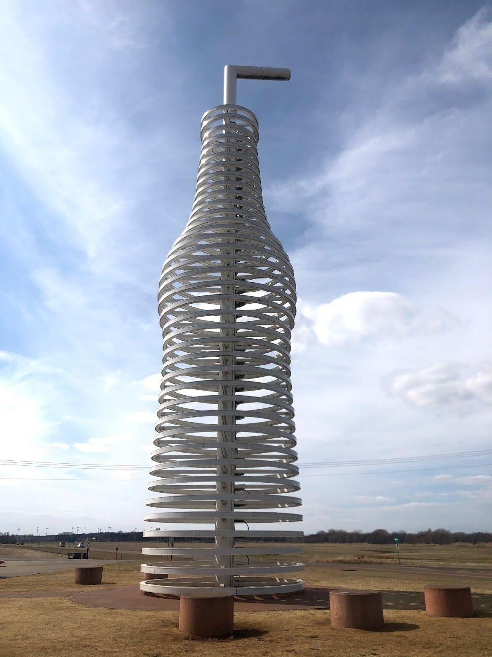 A large white sculpture resembling a soda bottle.