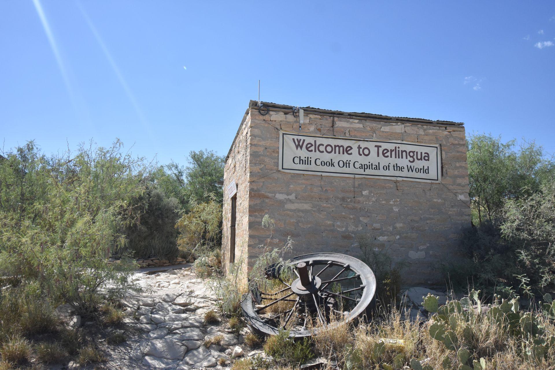 A former jailhouse with a banner that reads 'Welcome to Terlingua. Chili Cook Off Capital of the World'