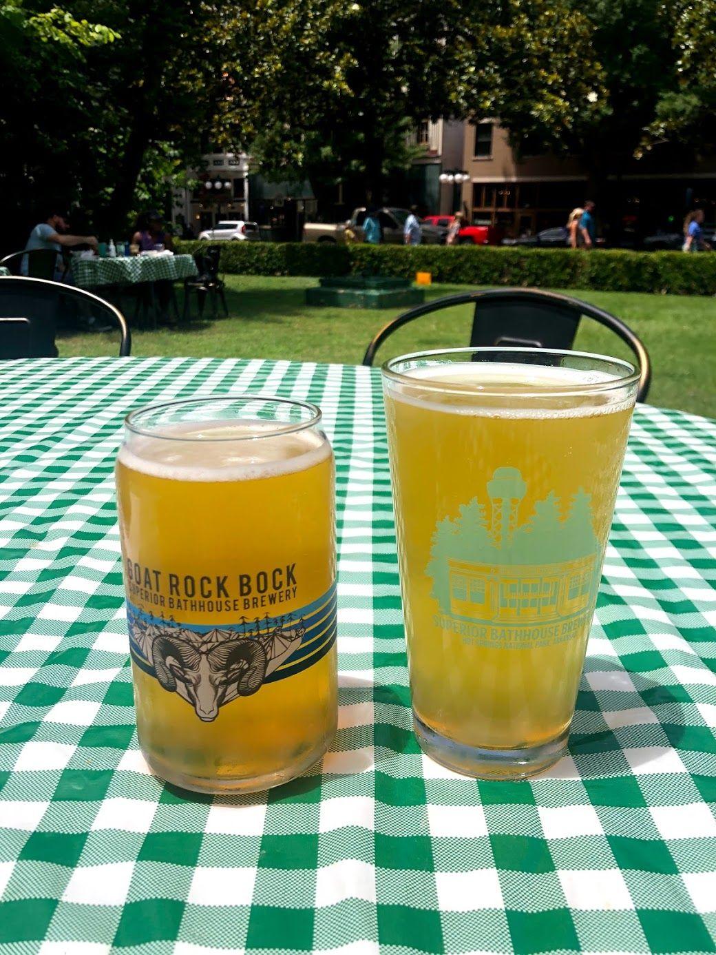 Two beers on a picnic table cloth outside of Superior Bathhouse Brewery.