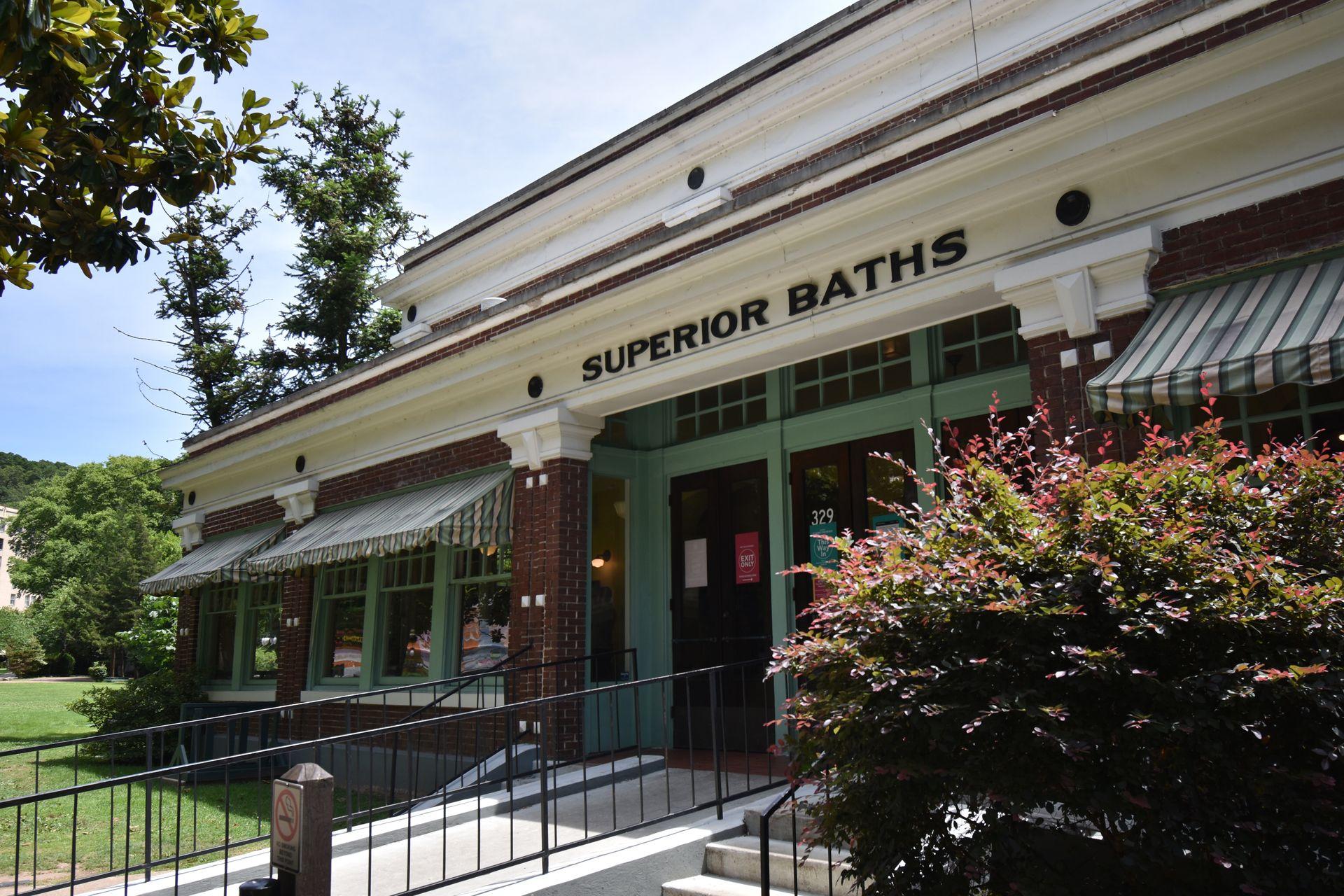 The exterior of Superior Bathhouse Brewery. The building has brown brick and green awnings.