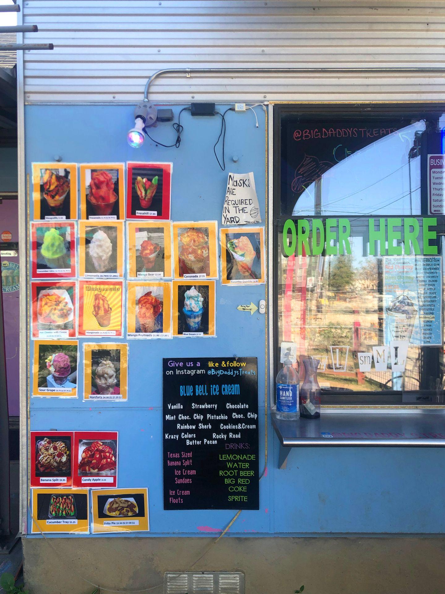 The order window at Big Daddy's Treats. There are photos of several menu options.