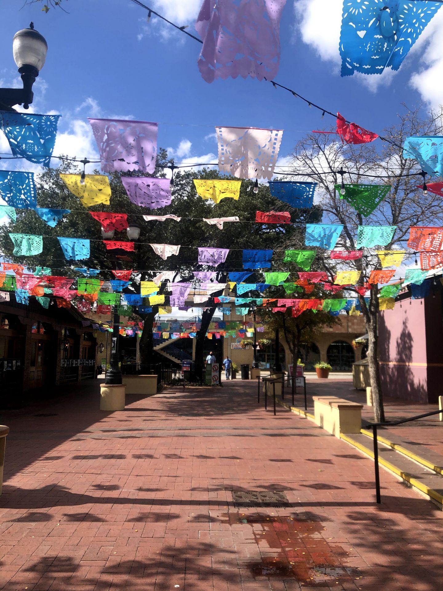 A pathway with colorful flags above it at the Historic Market Square.