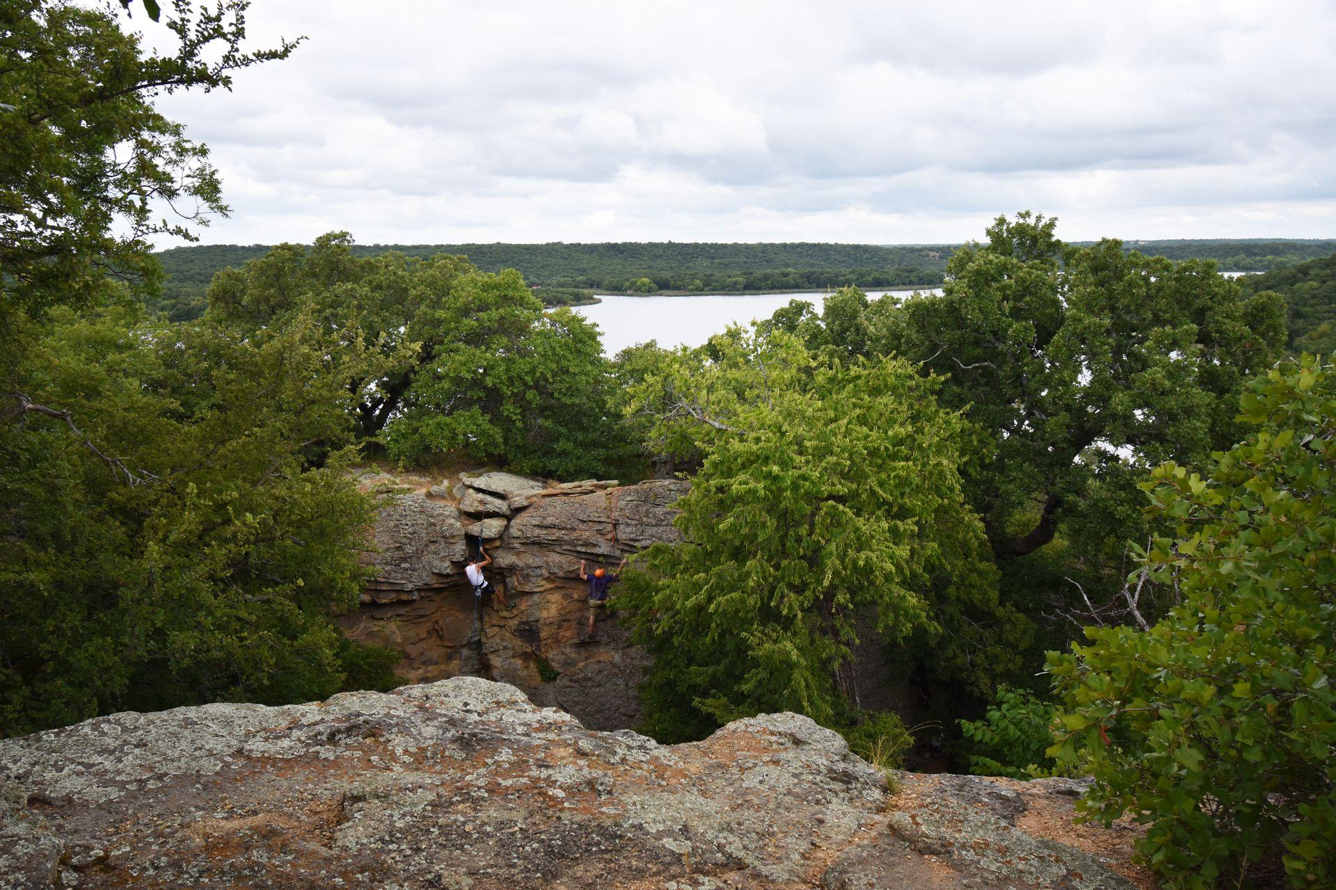 Rock climbers on their way up a rock in Minerall Wells State Park.