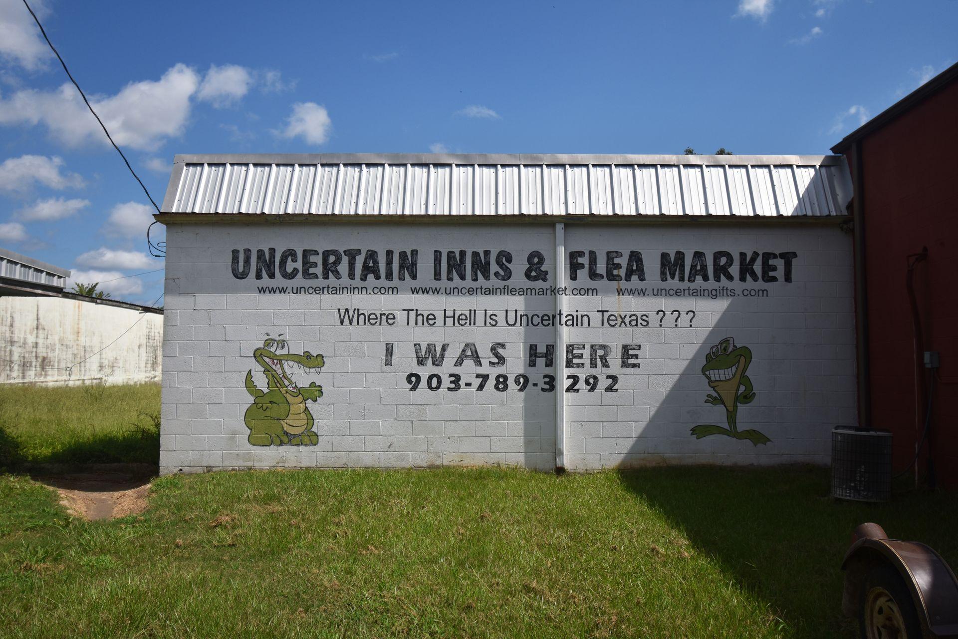 A mural reading "Uncertain Inns and Flea Market," "Where the hell is Uncertain, Texas???" and "I was here"