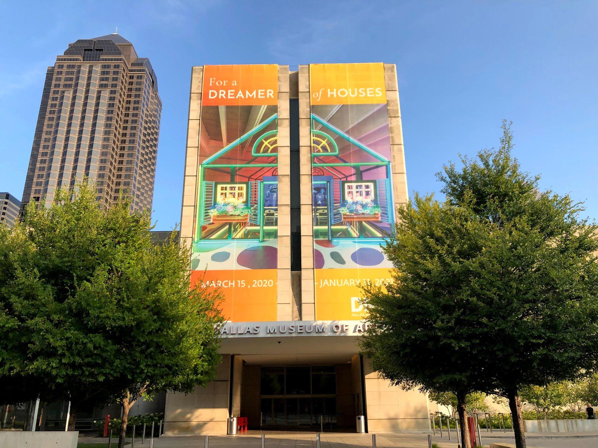 The exterior of the DMA (Dallas Art Museum) with a huge sign for the "Dreamer of Houses" special exhibition.