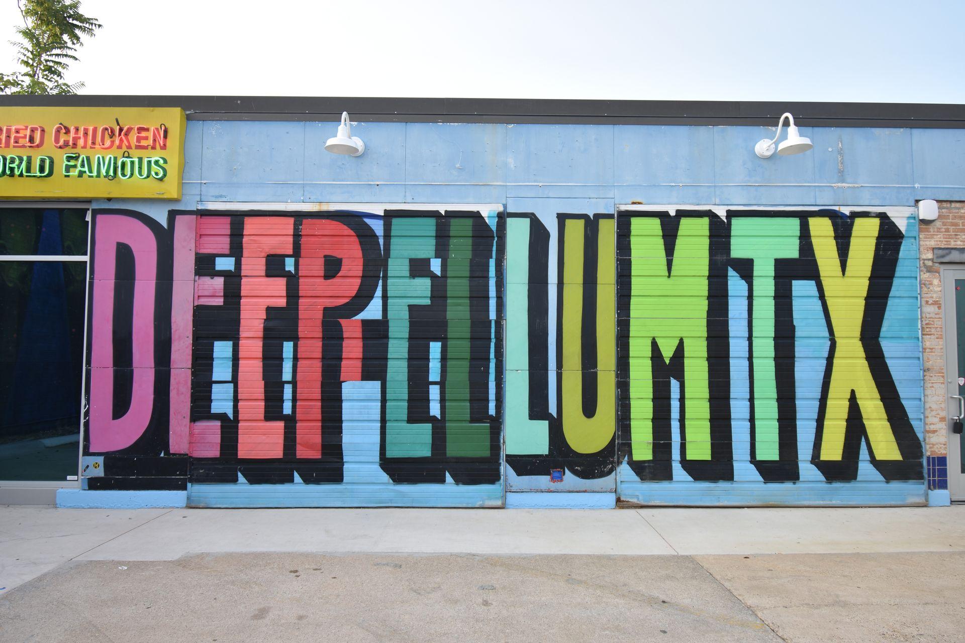 A colorful that reads "Deep Ellum TX" in huge, colorful letters.