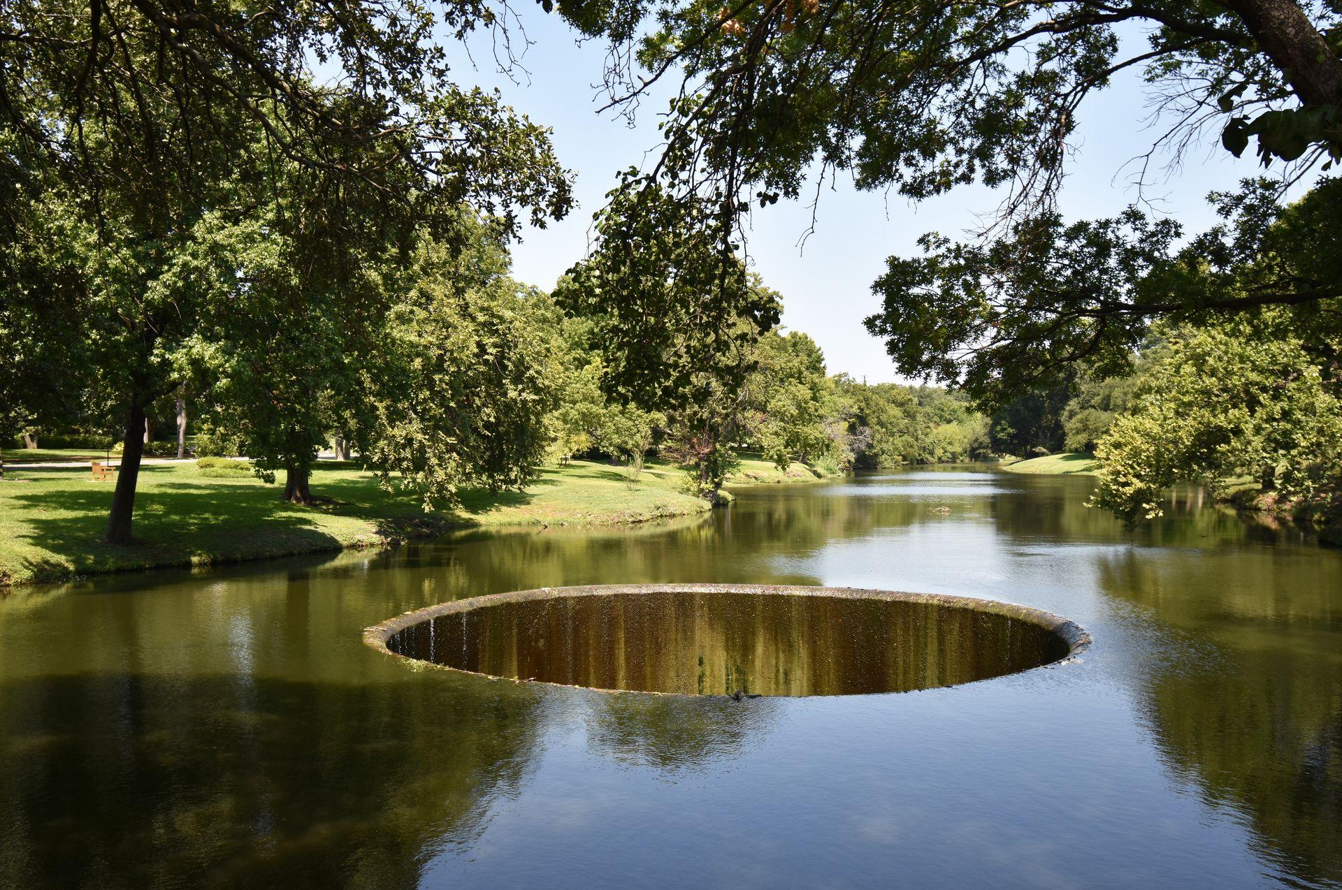 A huge hole in the middle of a waterway in Highland Park.