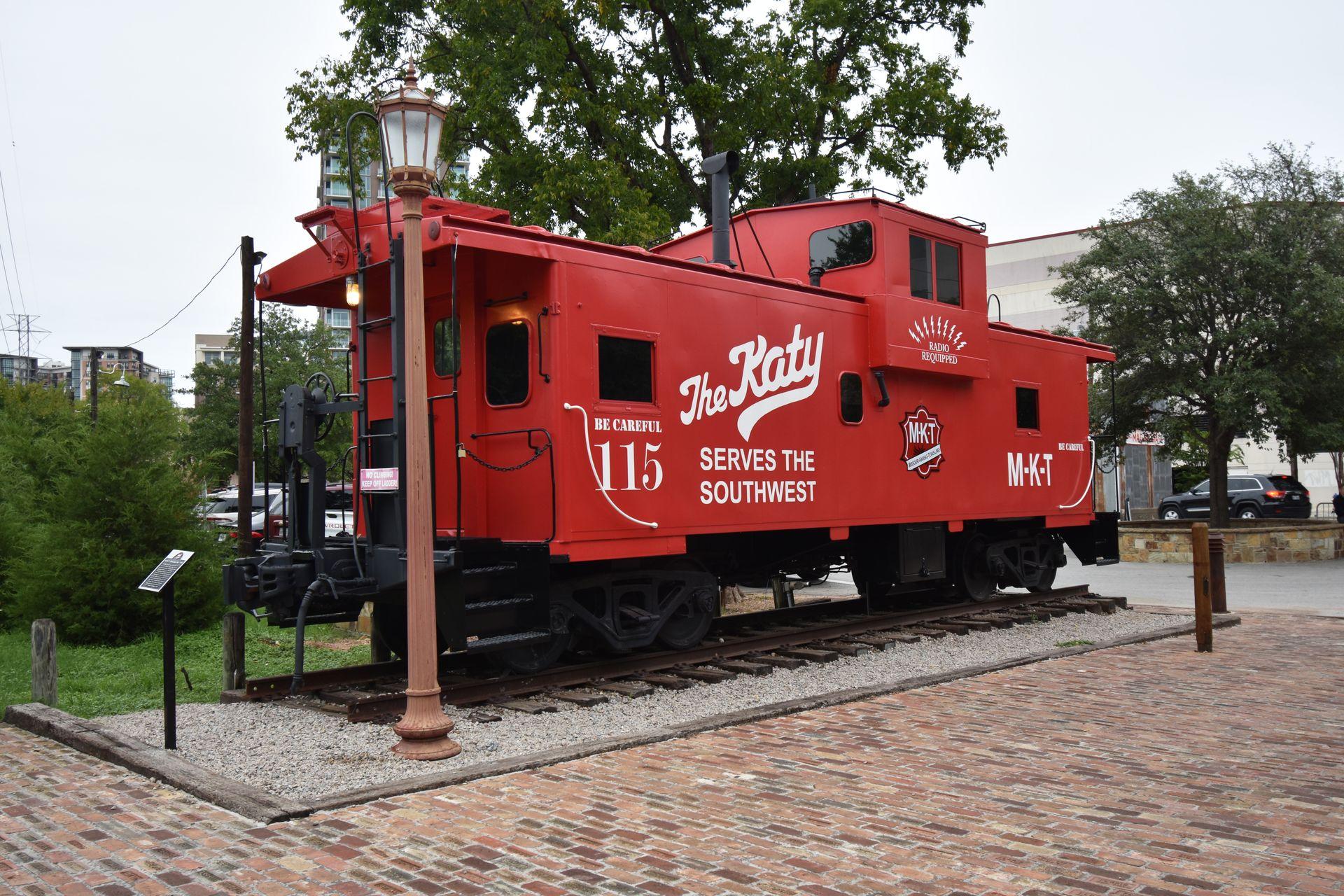 A red caboose that reads "The Katy" at the Katy Trail Ice House.