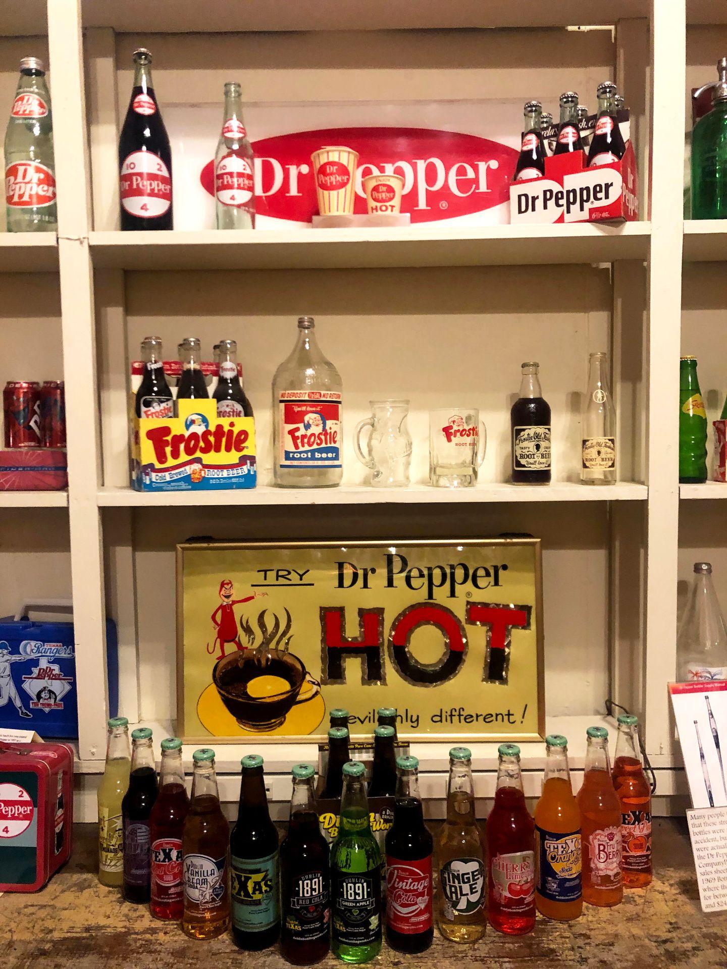 A display from the Dublin bottling works tour that includes a sign for hot Dr. Pepper and Frostie root beer