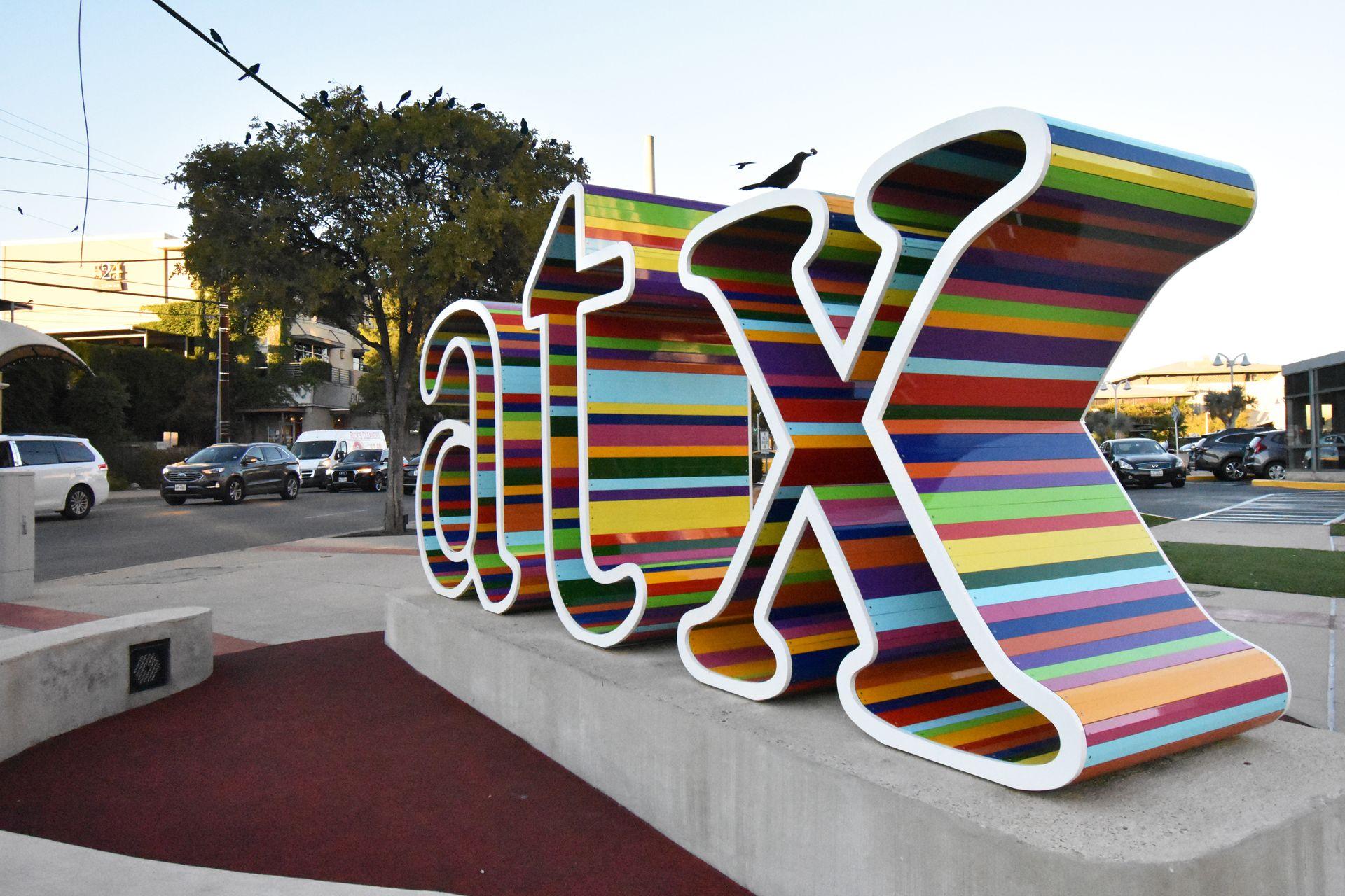 Colorful "atx" letters in front of a Whole Foods in Austin.