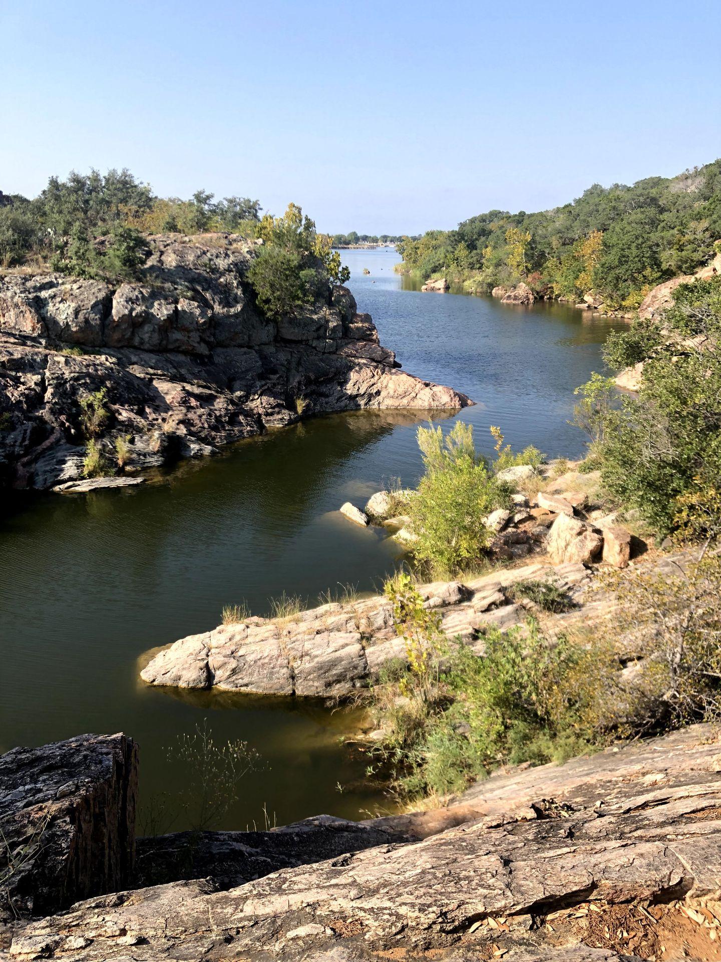 An area of water winding around rocks at Inks Lake State Park.