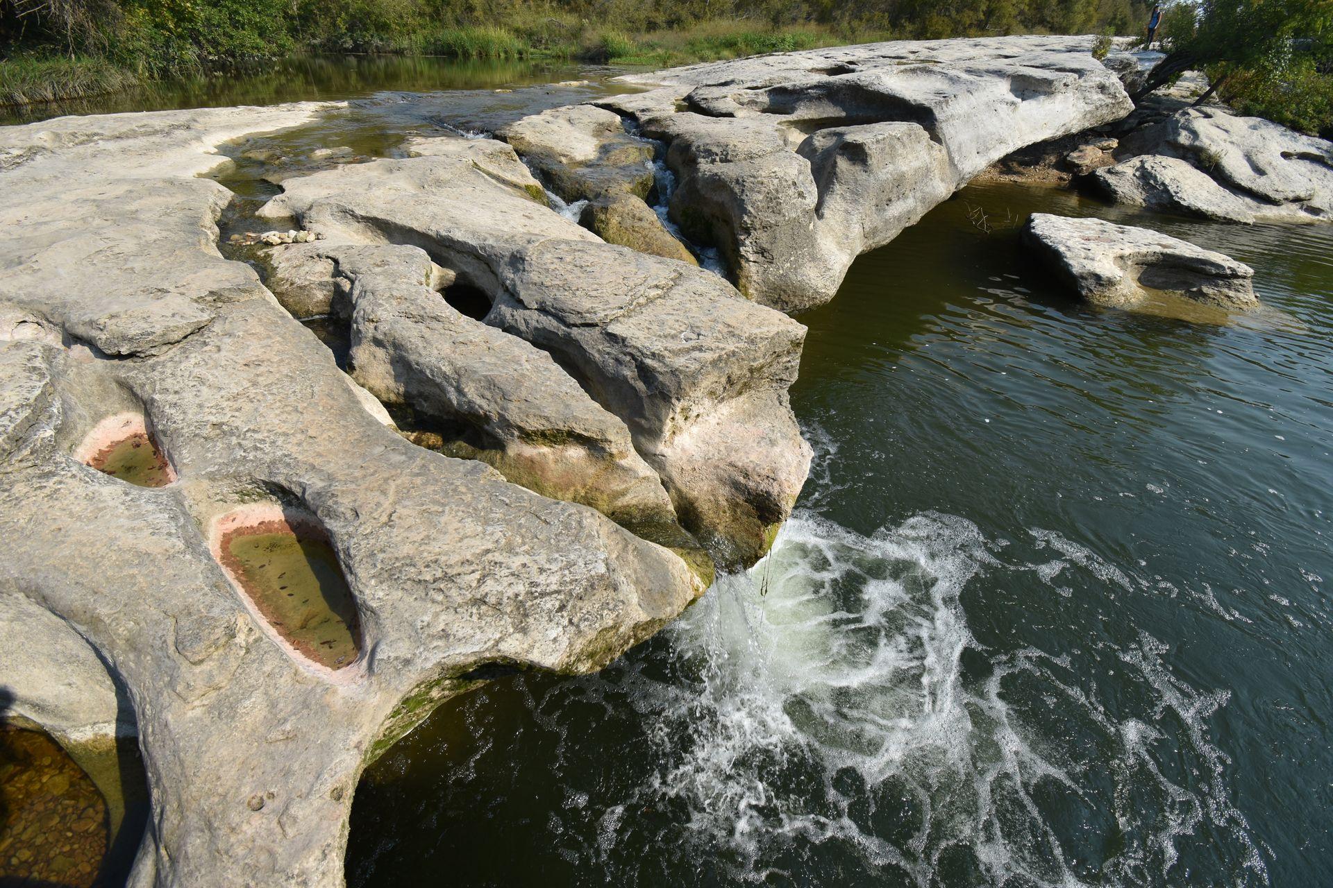 A waterfall cascading over rocks at McKinney Falls State Park