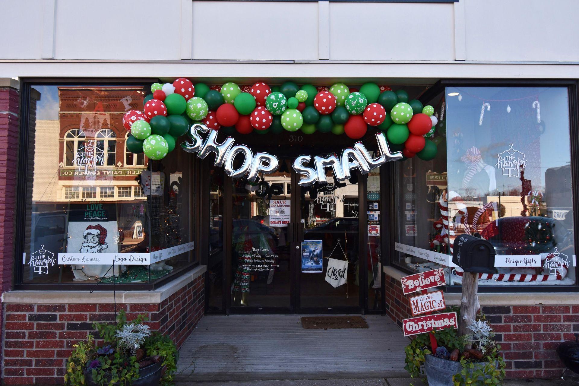 A shop with balloons that read "Shop Small" in Downtown Denison