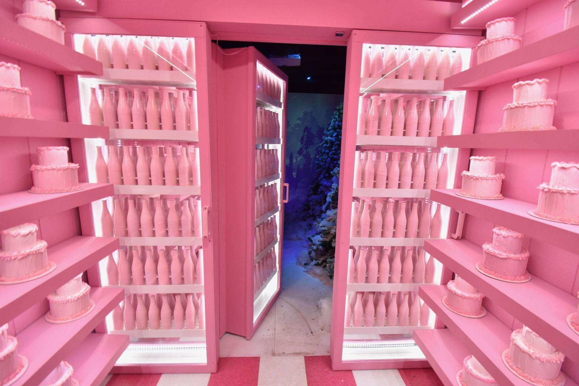 A pink room with a door opening up into a winter wonderland at the Sweet Tooth Hotel pop up in Denison.