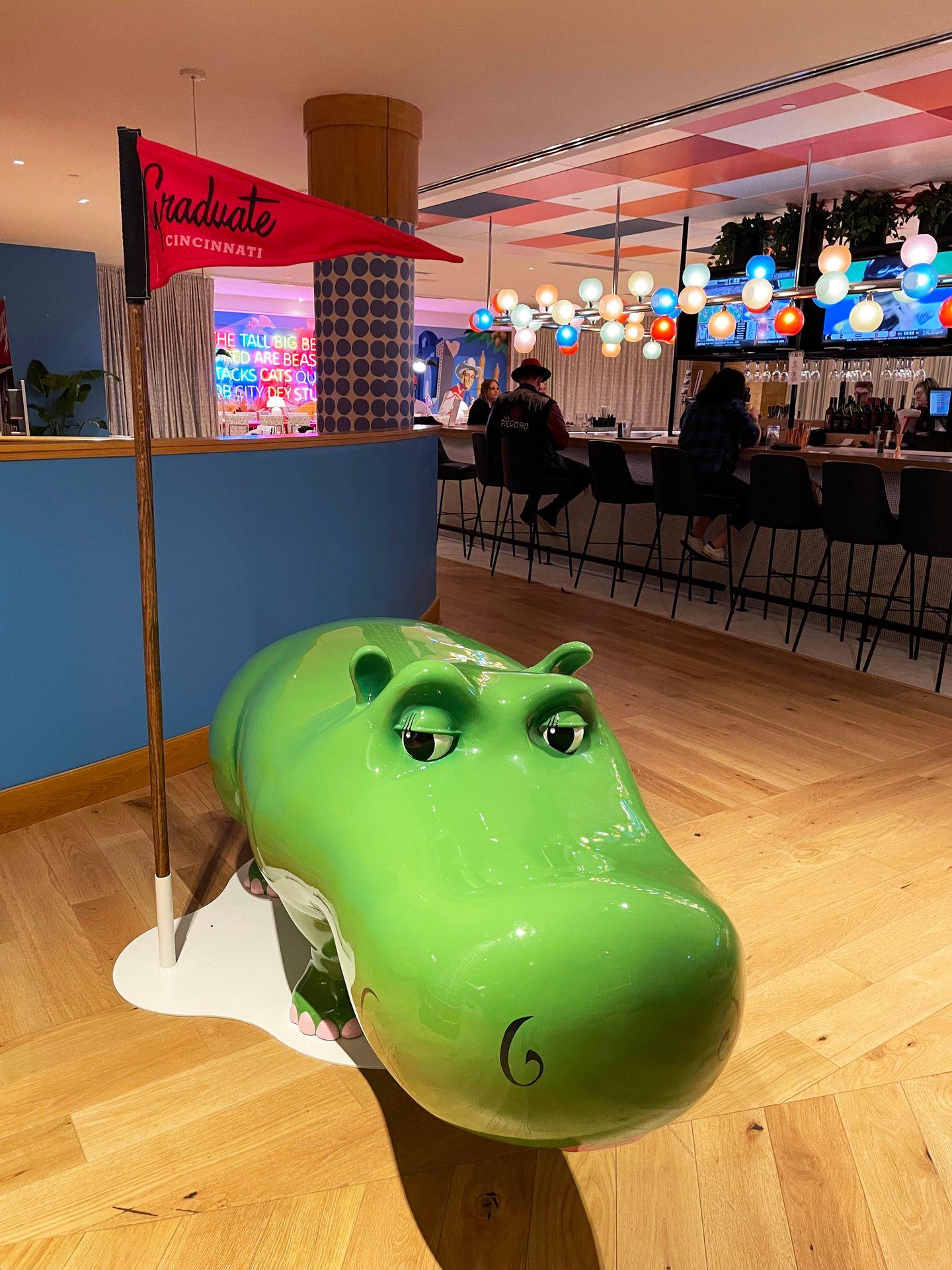 A green hippo statue in the lobby of the Graduate Cincinnati hotel.