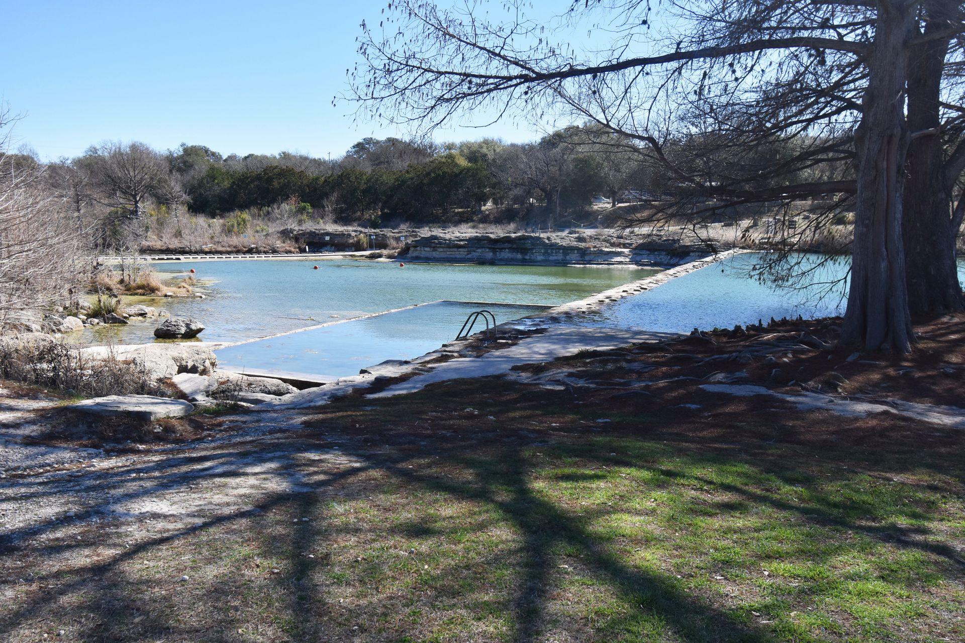 A view of the swimming area and a dam in Blanco State Park.