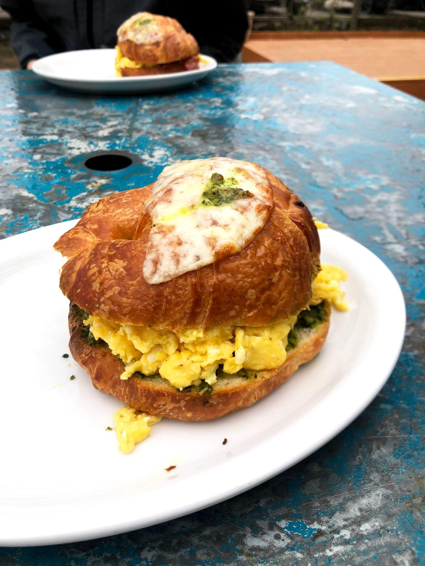 A croissant sandwich with eggs and pesto from Rolling in Thyme and Dough.
