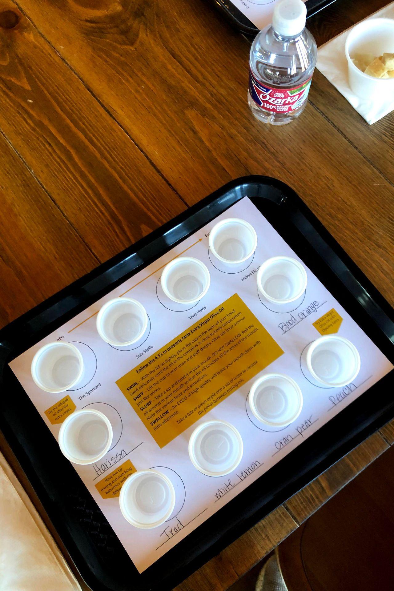A tray of 10 plastic cups for olive oil samples.