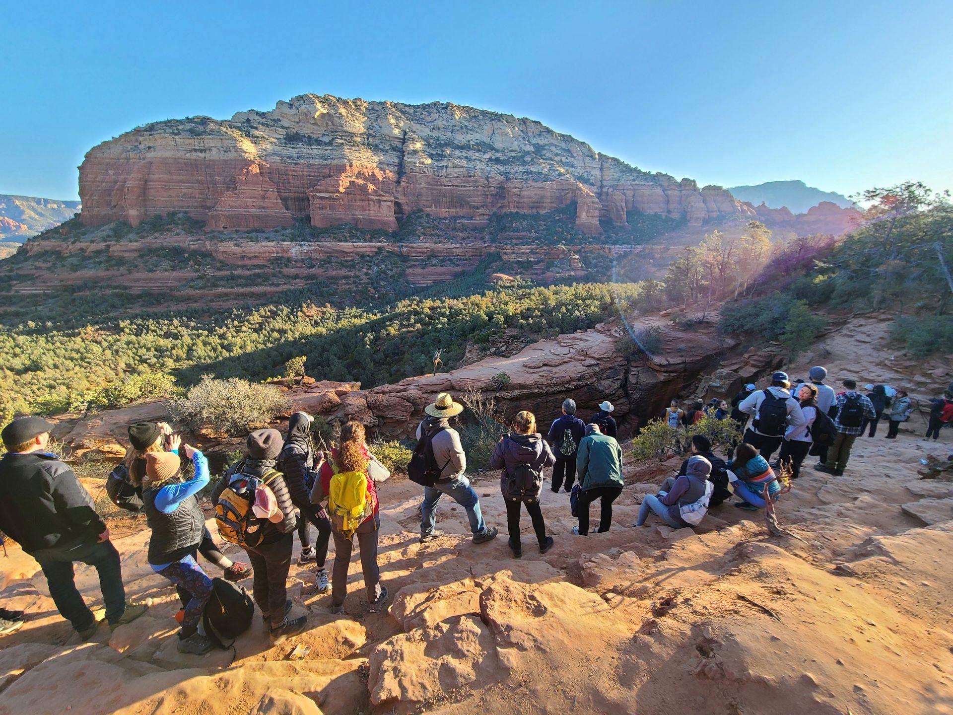 A line of at least 20 people waiting to take a photo on Devil's Bridge.