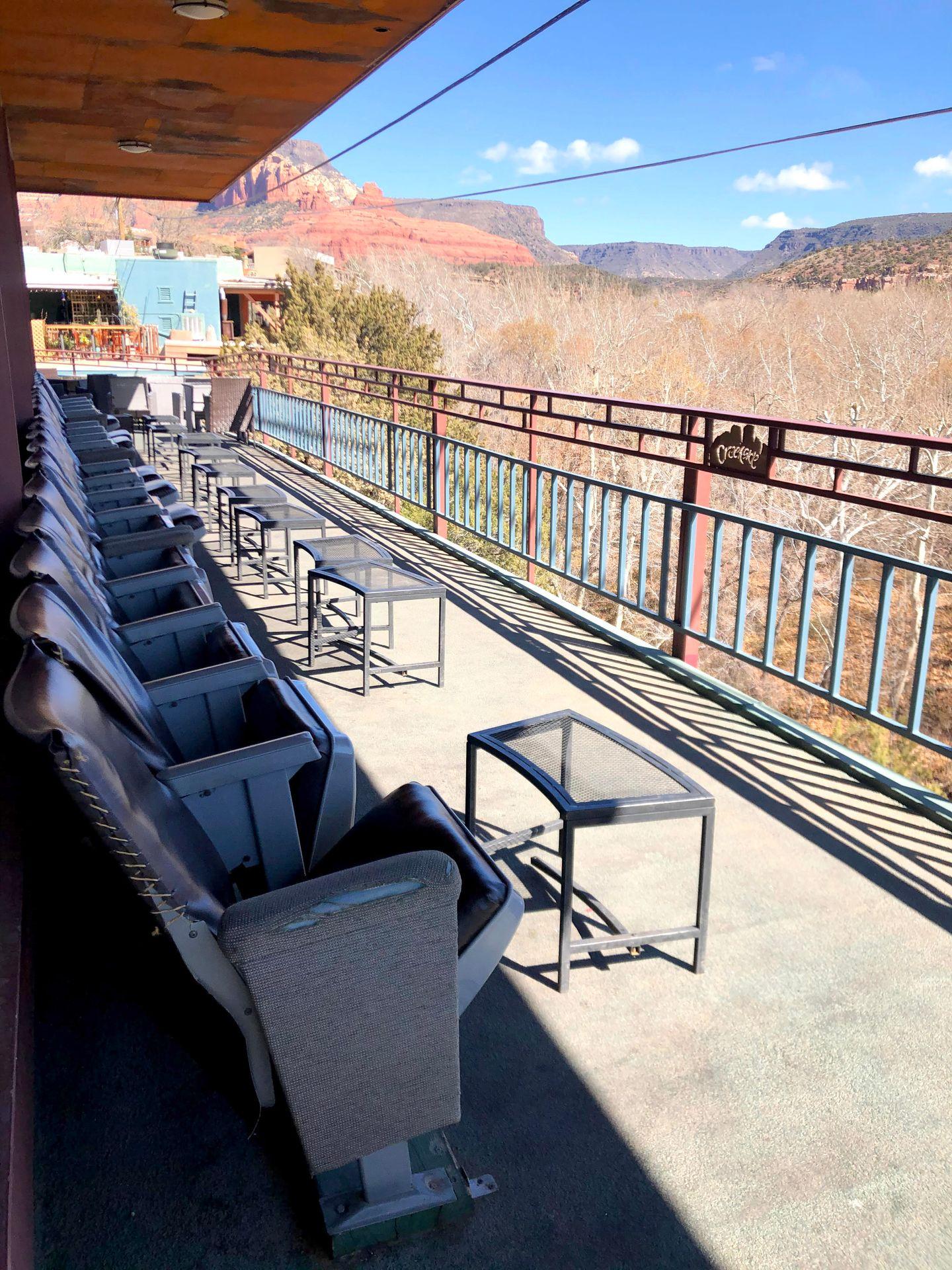 A row of seats facing out towards the view on the deck of Creekside Coffee.