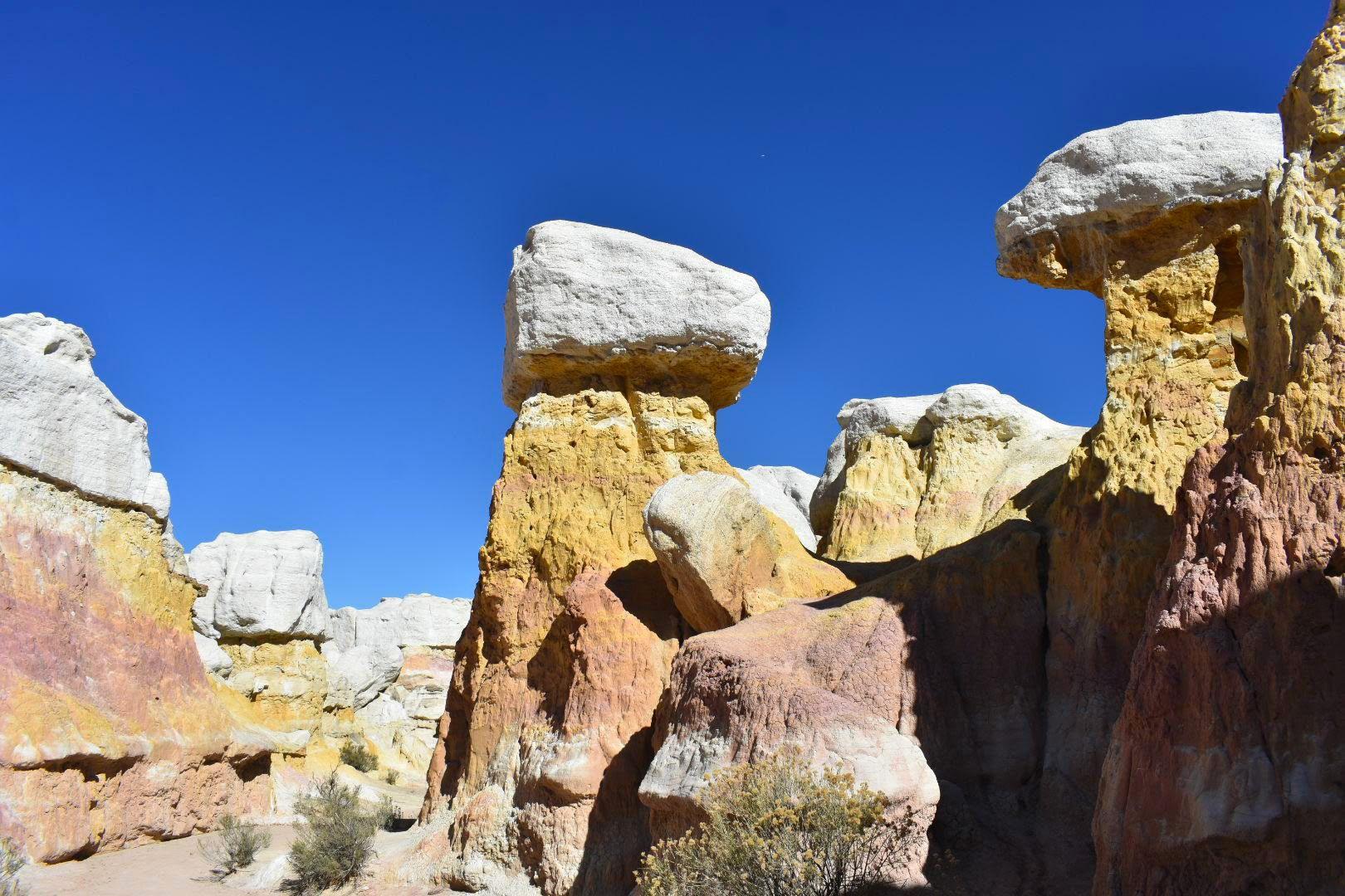 Several giant red, pink and yellow rocks at the Paint Mines Interpretive Park.