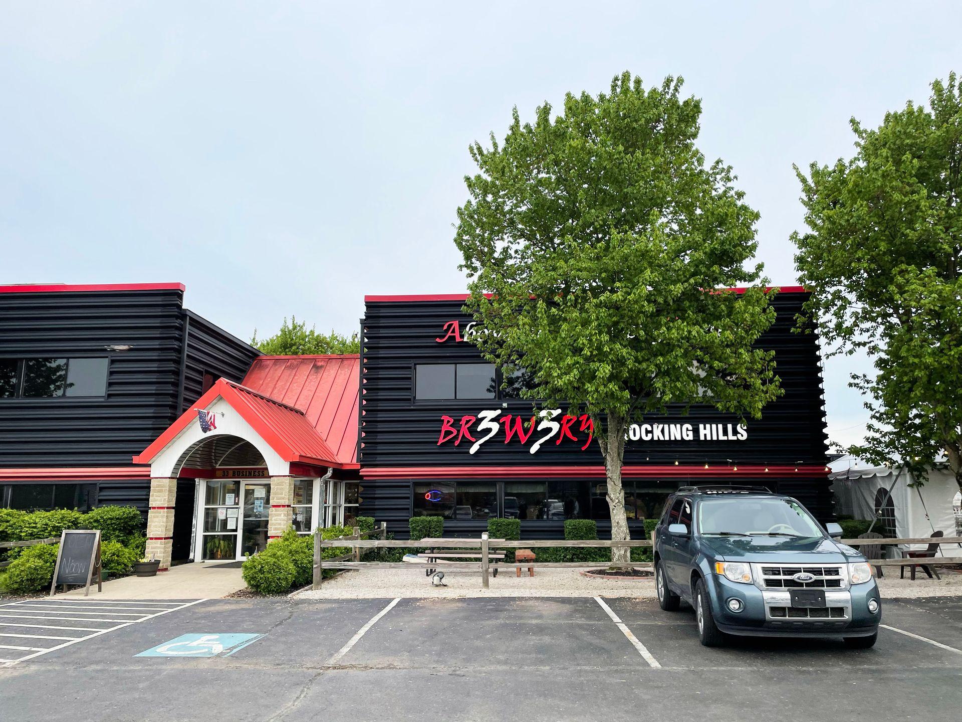 The exterior fo Brewery 33, a black and red building.