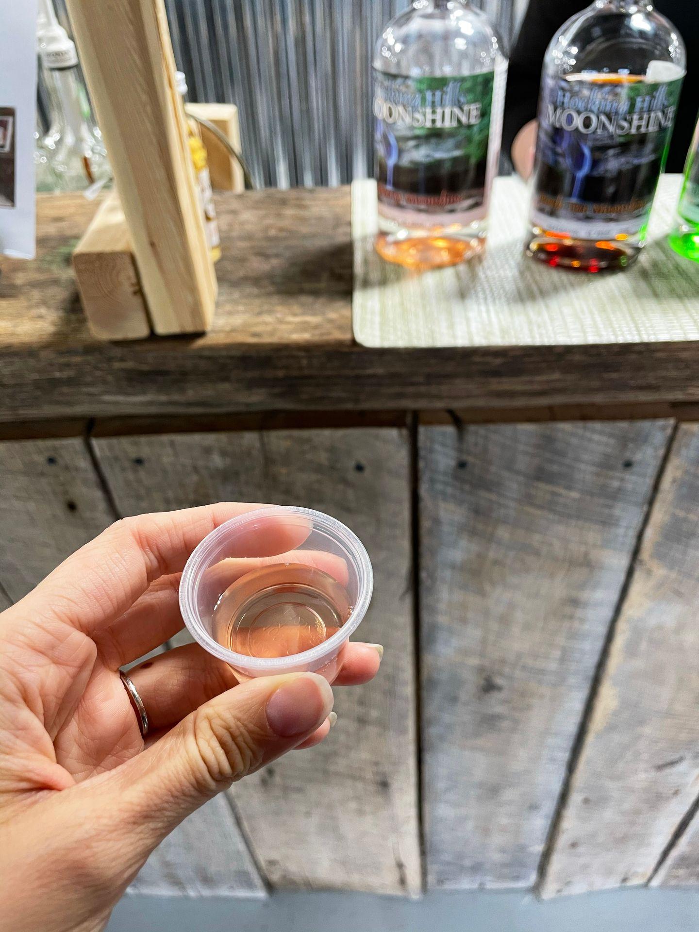 A small sample cup of moonshine.
