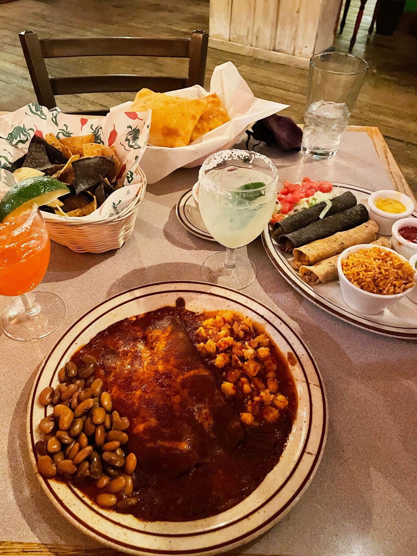 A table with enchiladas, margaritas, chips and other dishes from La Choza.