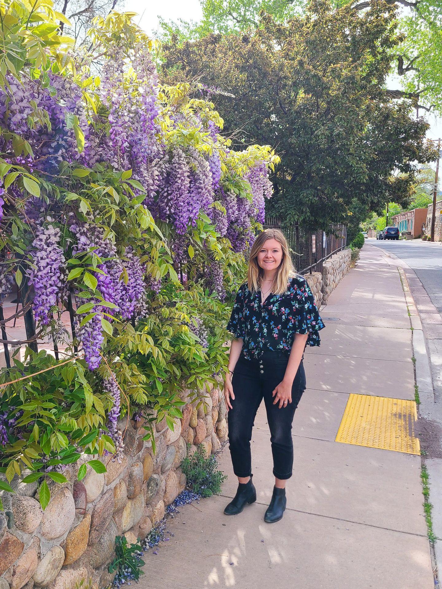 Lydia standing next to flowers on Canyon Road