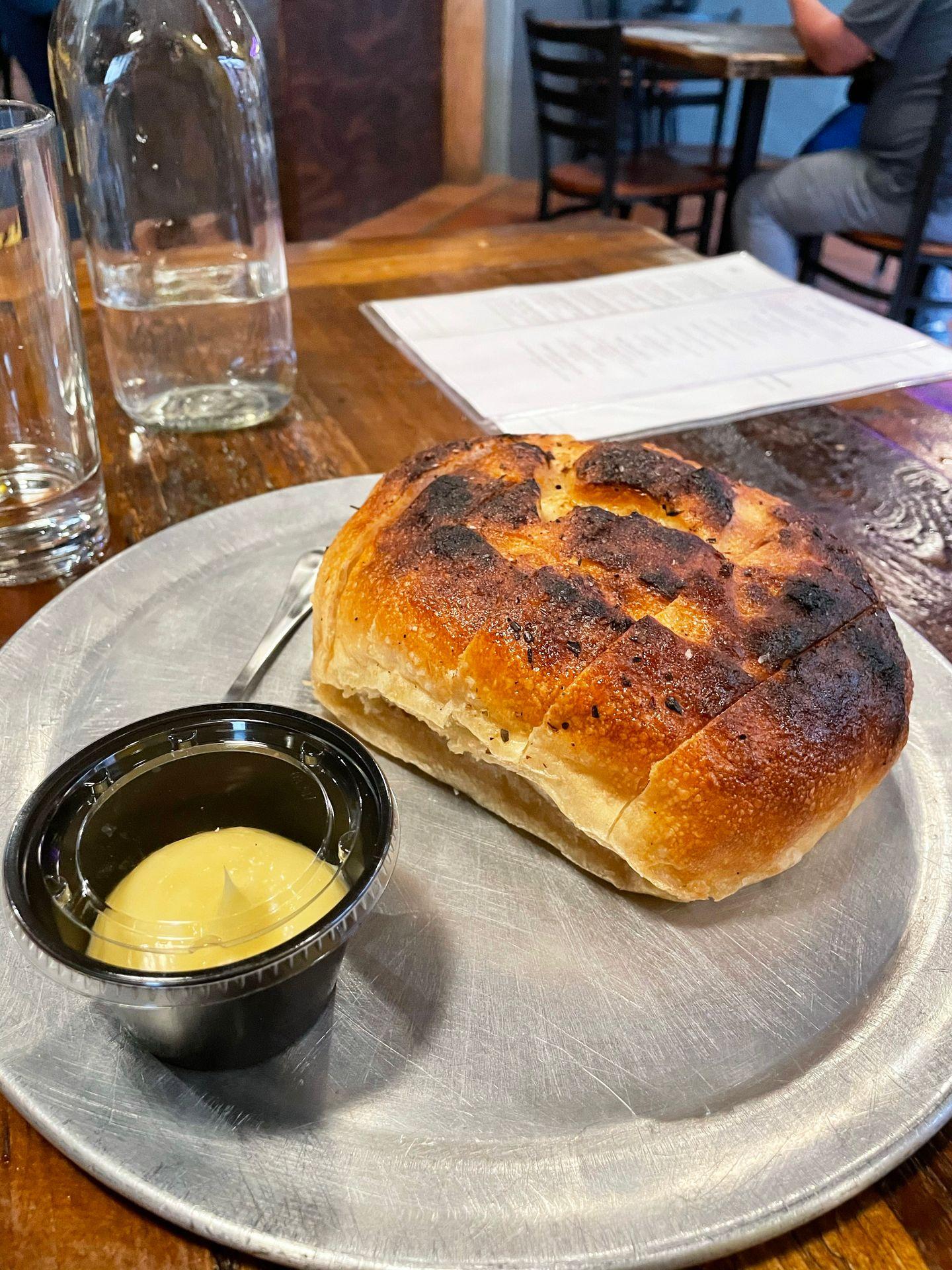 A loaf of bread with whipped butter next to it.