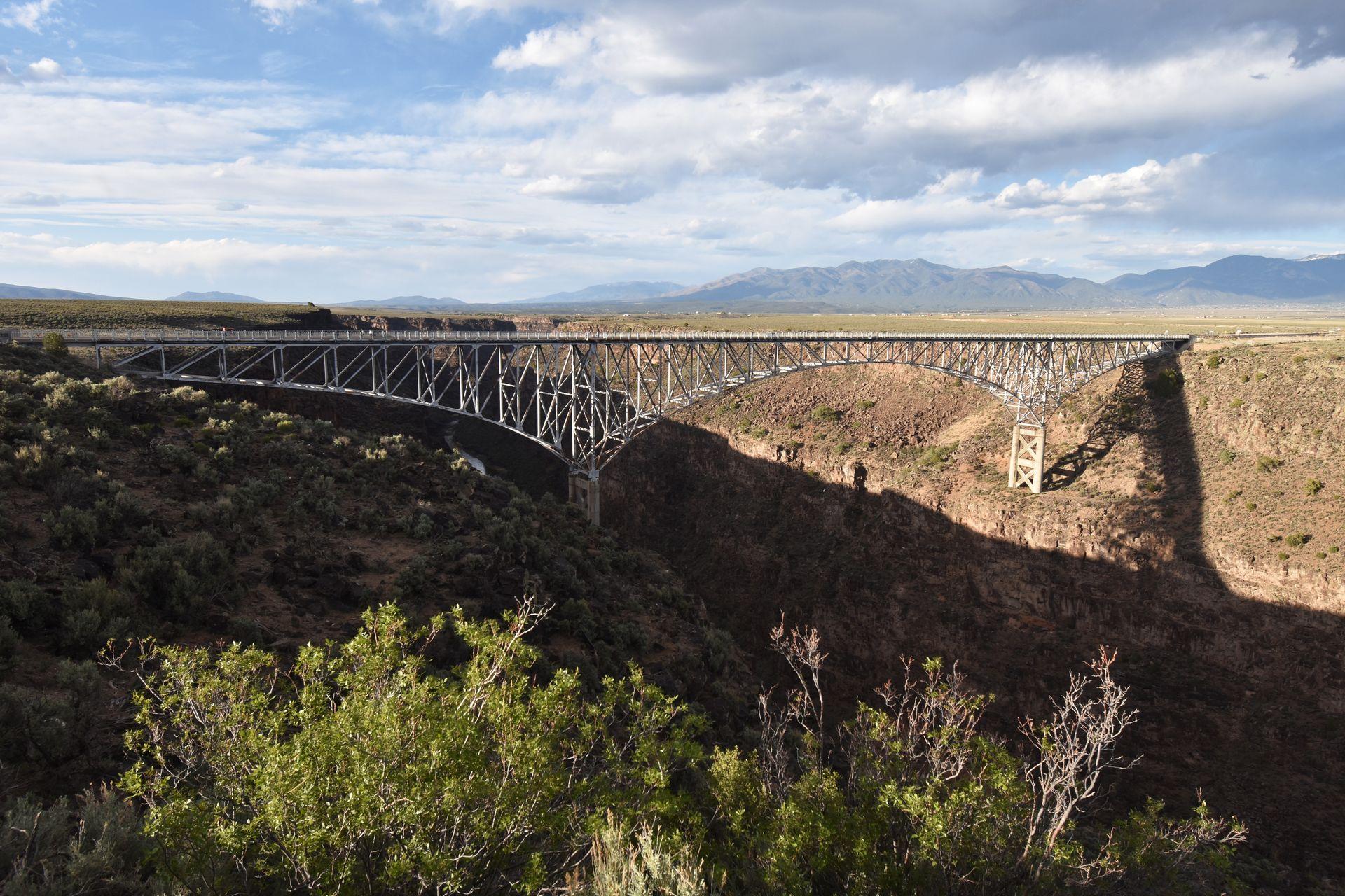 A view of a giant gorge with the Rio Grande Gorge Bridge crossing over the gorge.