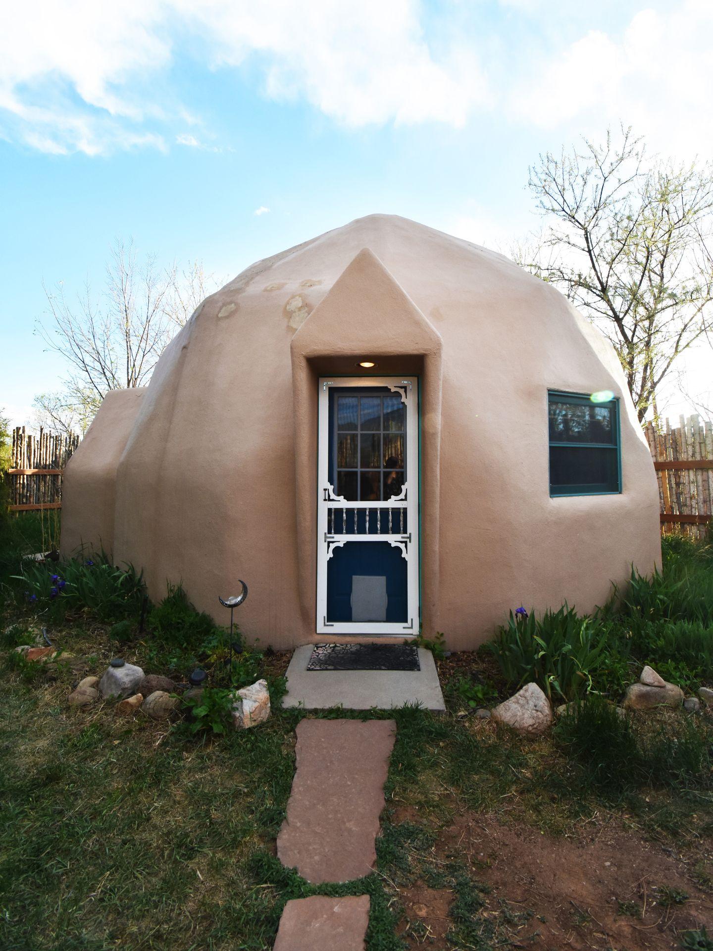 The exterior of a natural-colored Dome House in Taos.