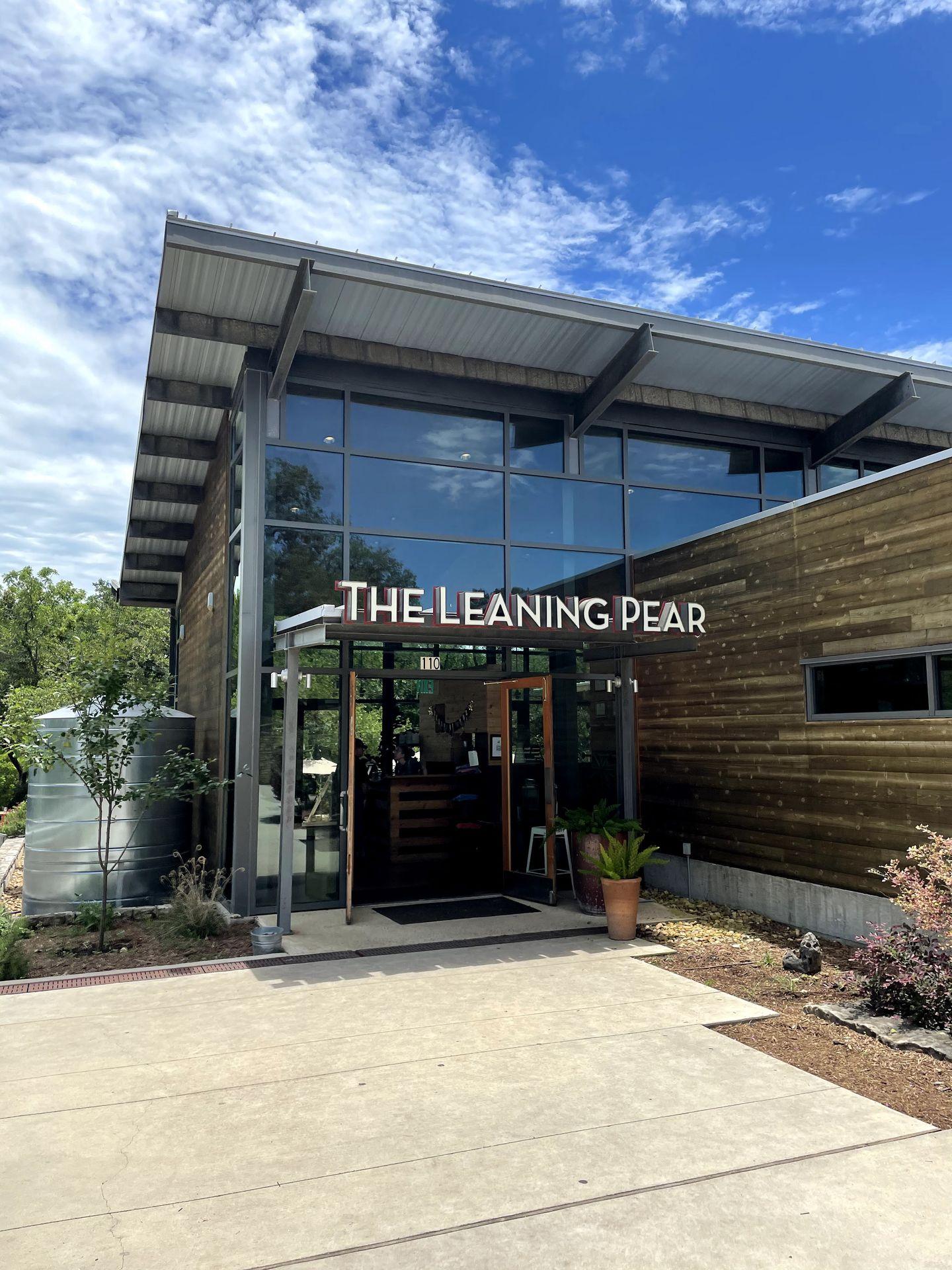 The exterior of The Leaning Pear, which looks modern with a lot of glass windows.