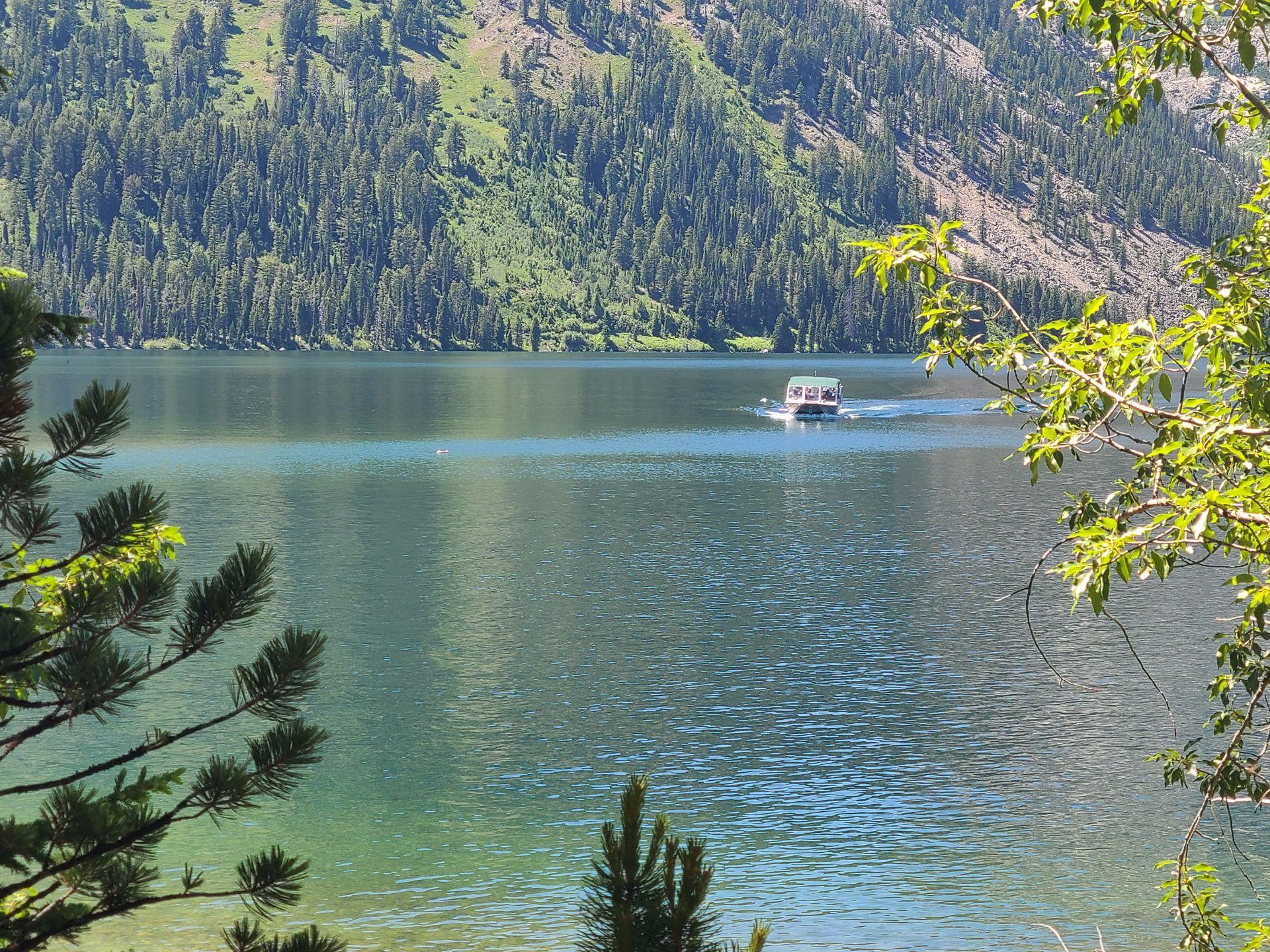 A boat traveling across Jenny Lake.