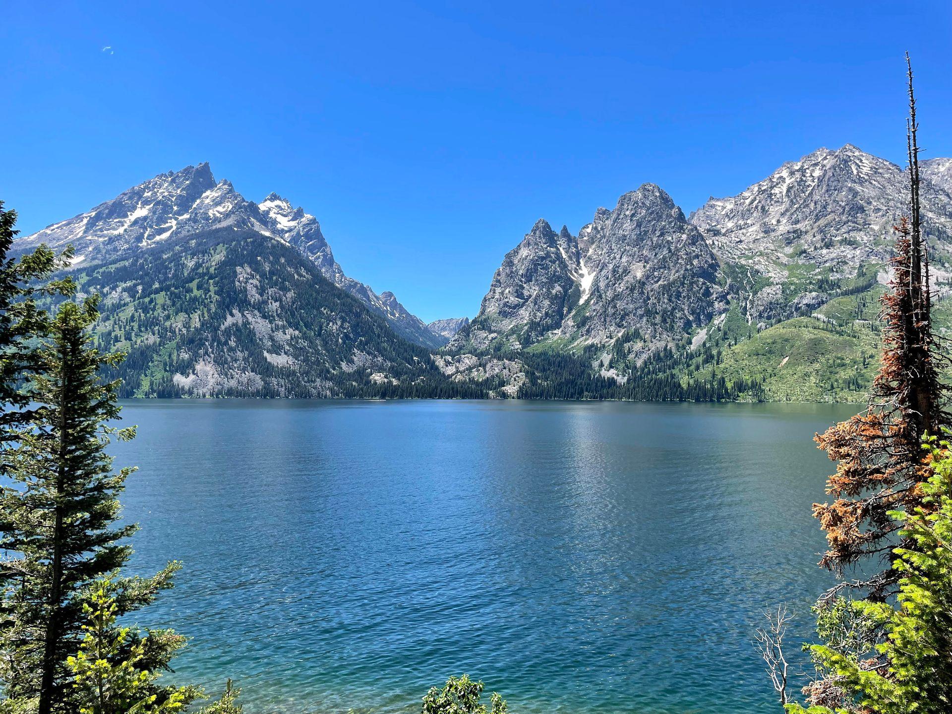 A view of Jenny Lake with beautiful mountains across the lake.