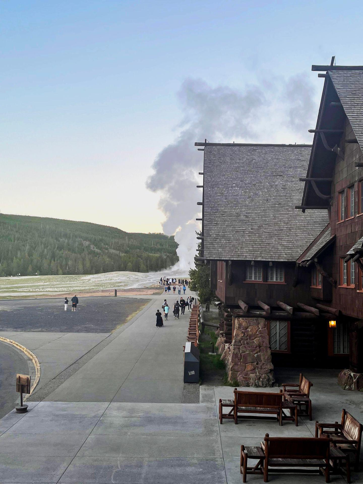A view of Old Faithful erupting from the balcony of the Old Faithful Inn