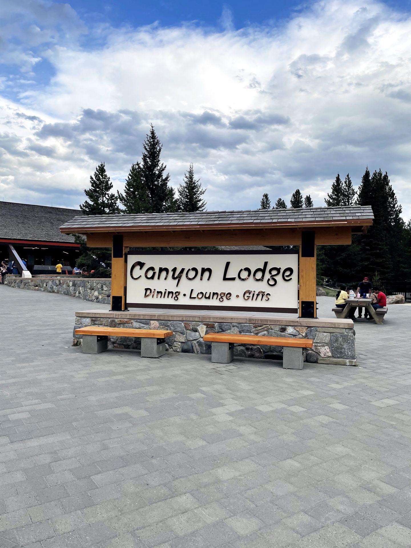 A sign for Canyon Lodge with the words "Dining-Lounge-Gifts"