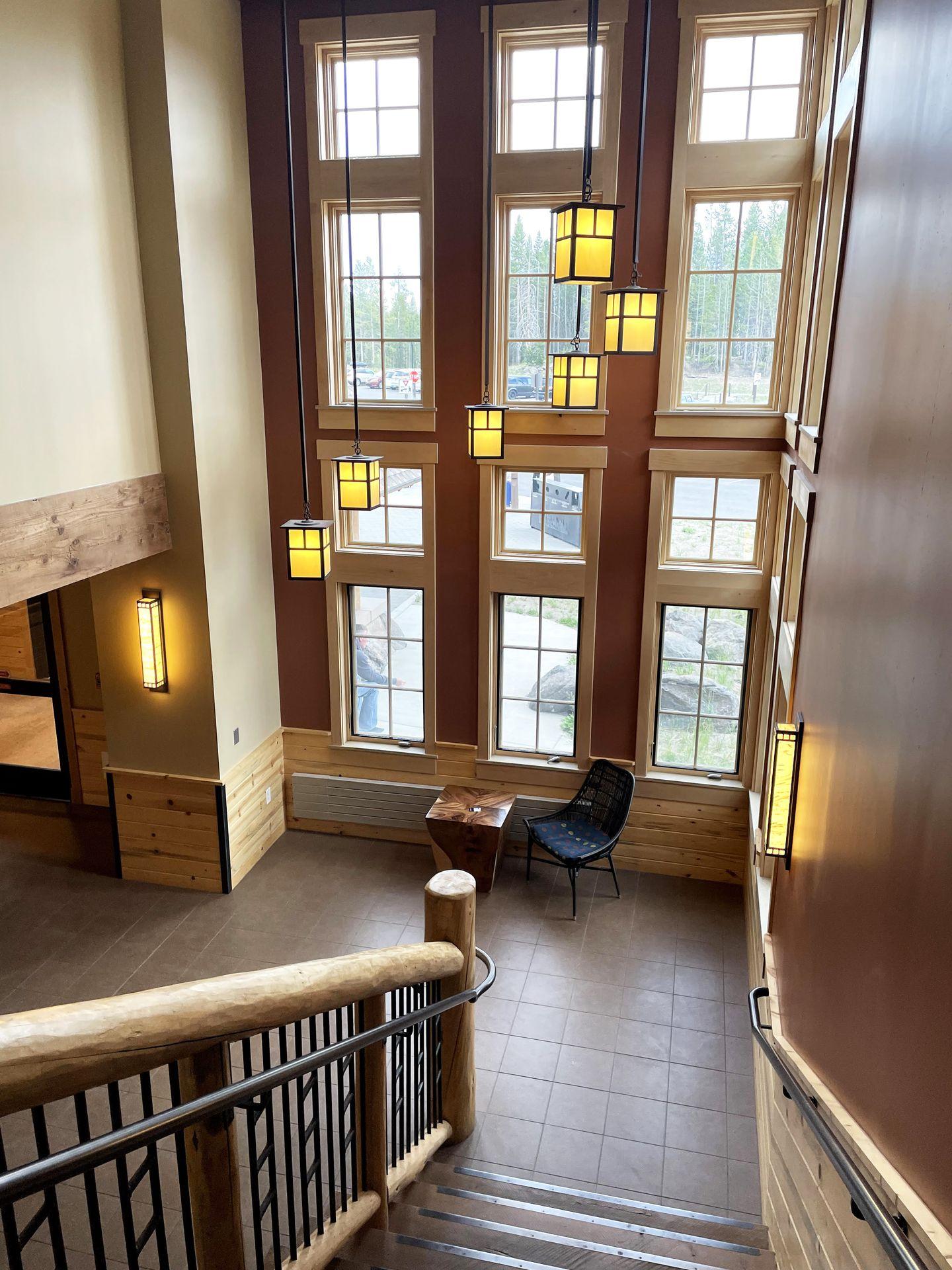 A stairway area with giant windows inside one of the Canyon Lodge buildings.