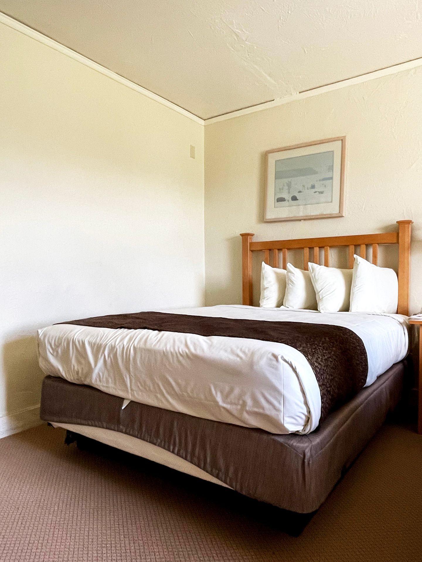 A basic bed in a room in the Old Faithful Inn