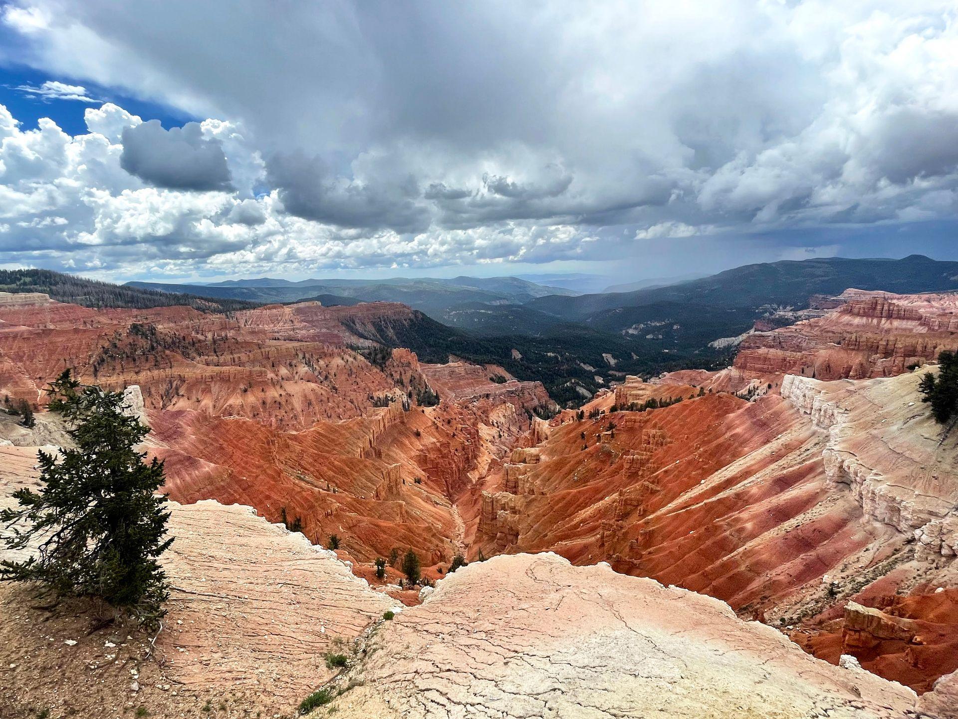 A view from an overlook at Cedar Breaks National Monument. There are orange rocks that resemble hoodoos.