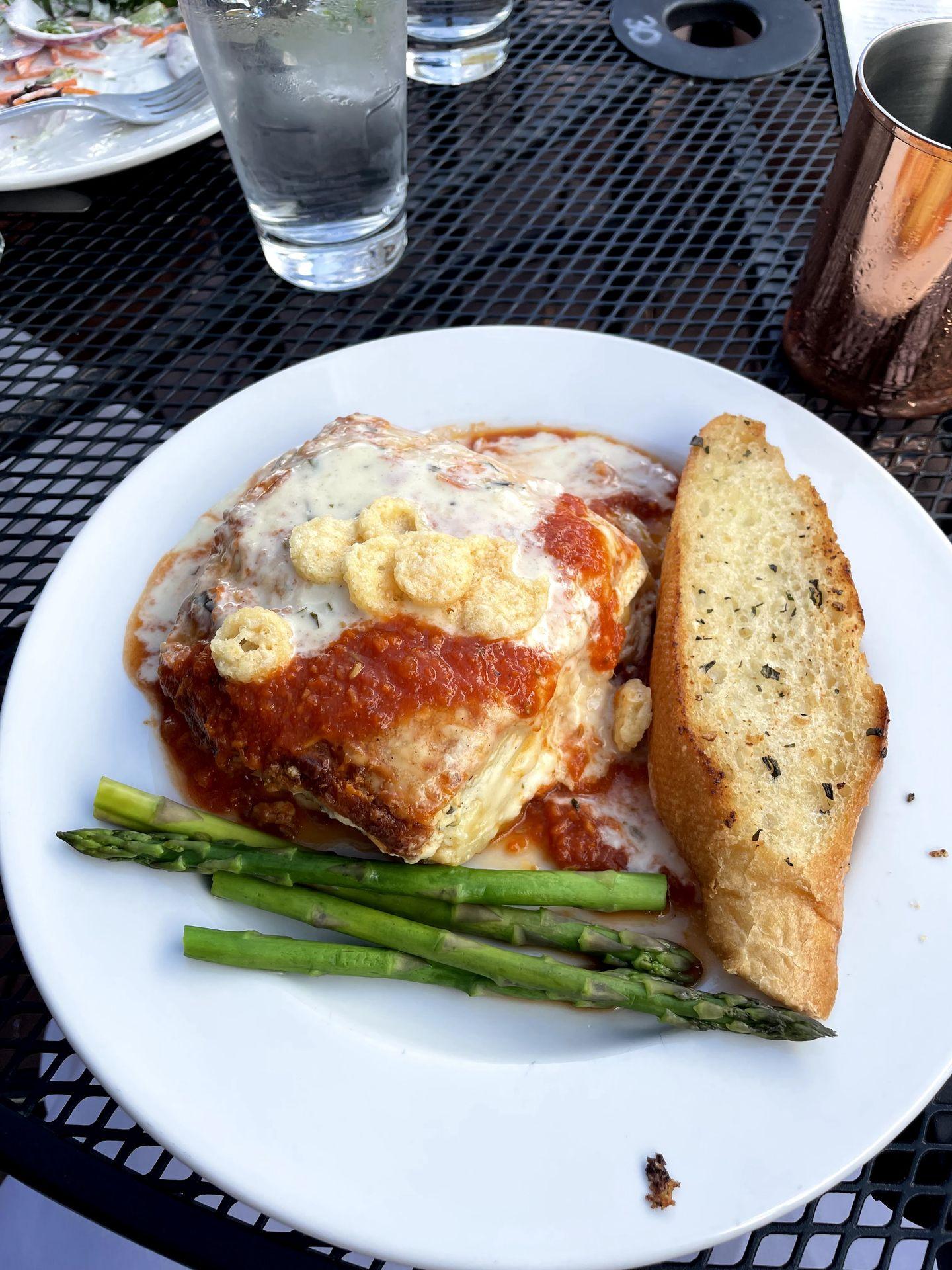 A plate of vegtable lasagna, asparagus and bread from Wild Thyme Cafe.