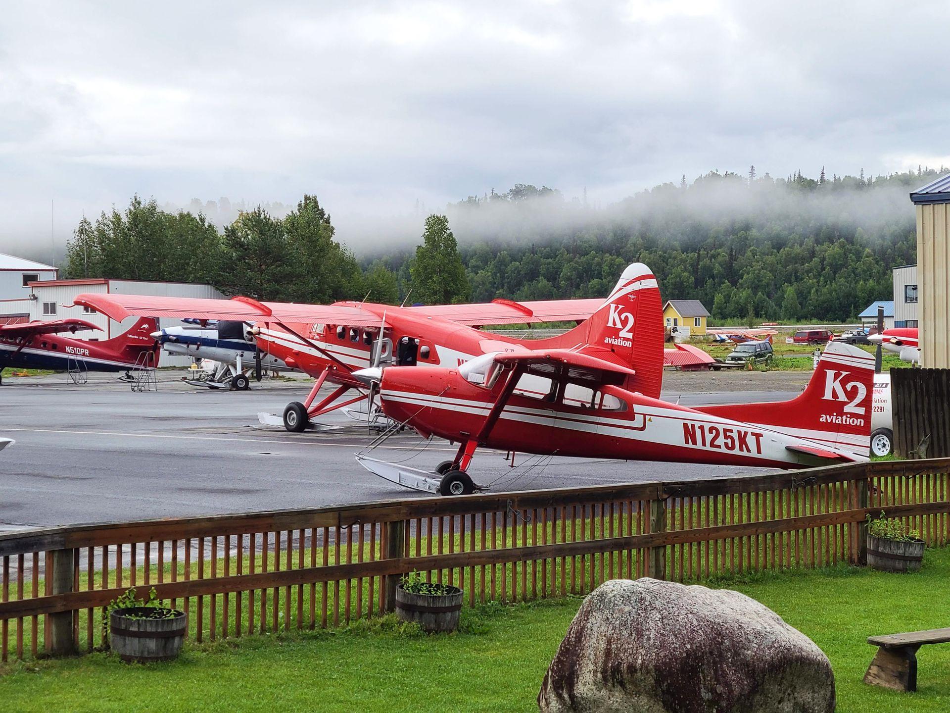 Red and white planes parked at K2 Aviation in Talkeetna.