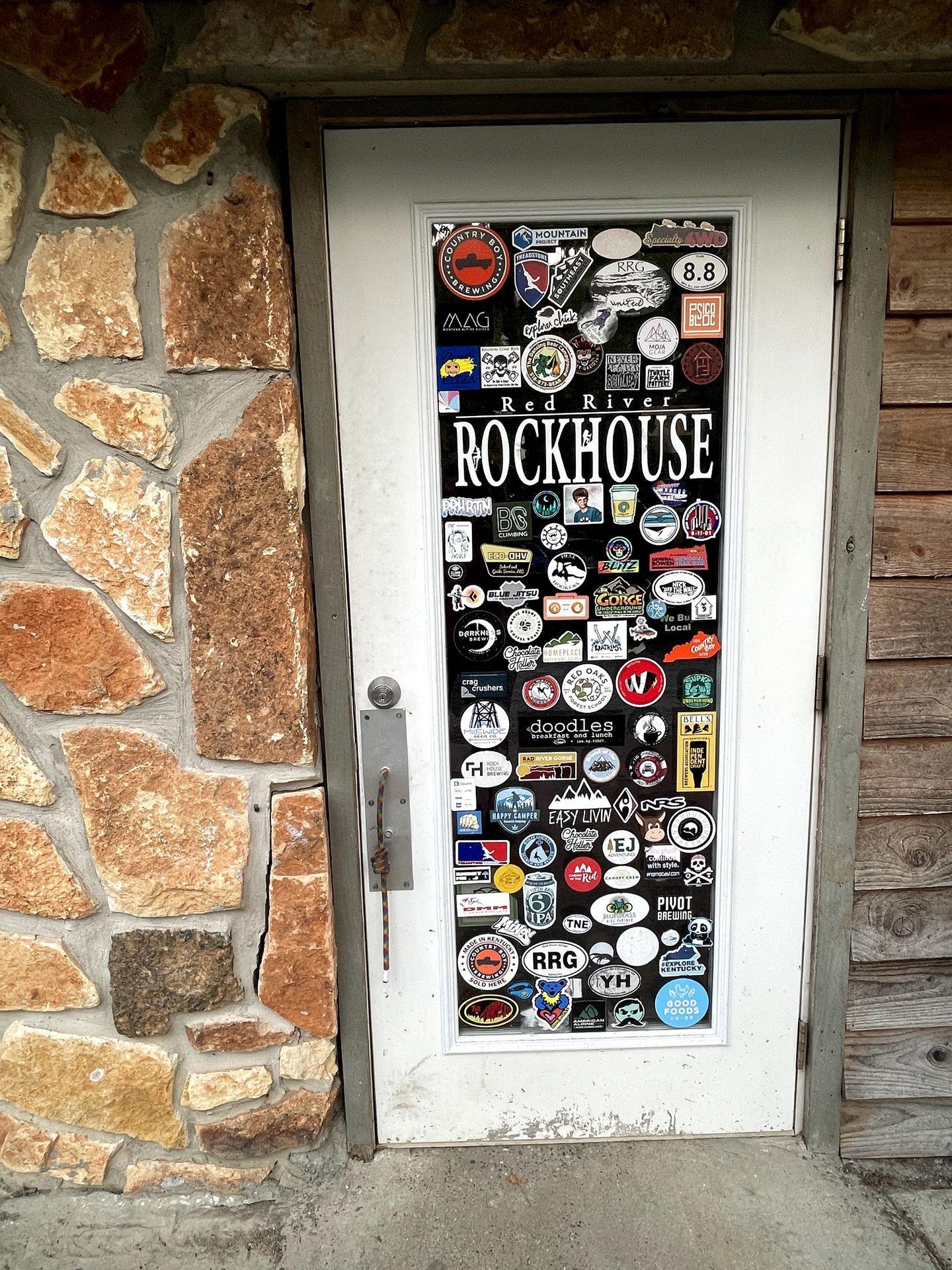 The door of Red River Rockhouse covered in stickers