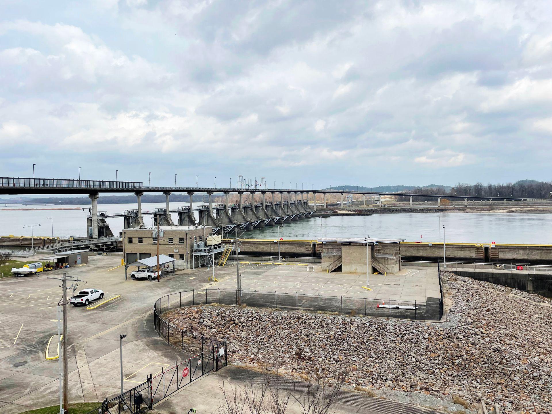 A view of the Big Dam Bridge from the shore. The interworkings of the dam are below and pedestrians can walk on top.