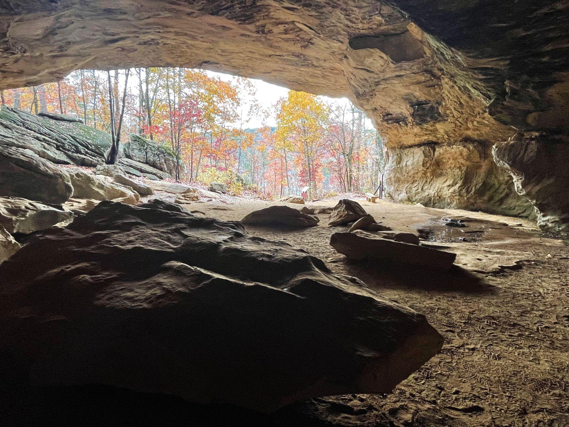 The inside of the Rock House. You can see colorful fall foliage outside of the cave.