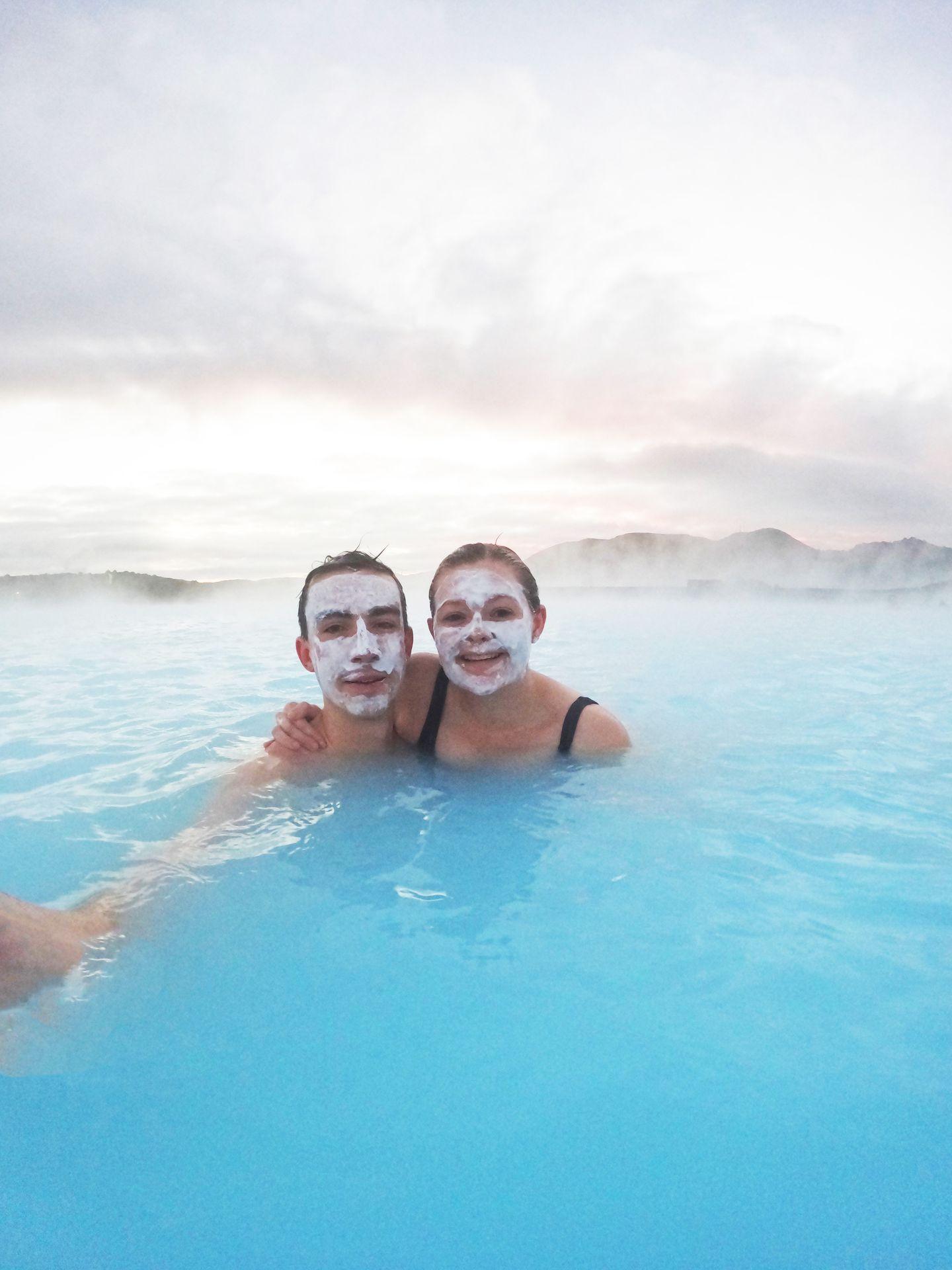 Lydia and Joe wearing face masks while swimming in the Blue Lagoon.