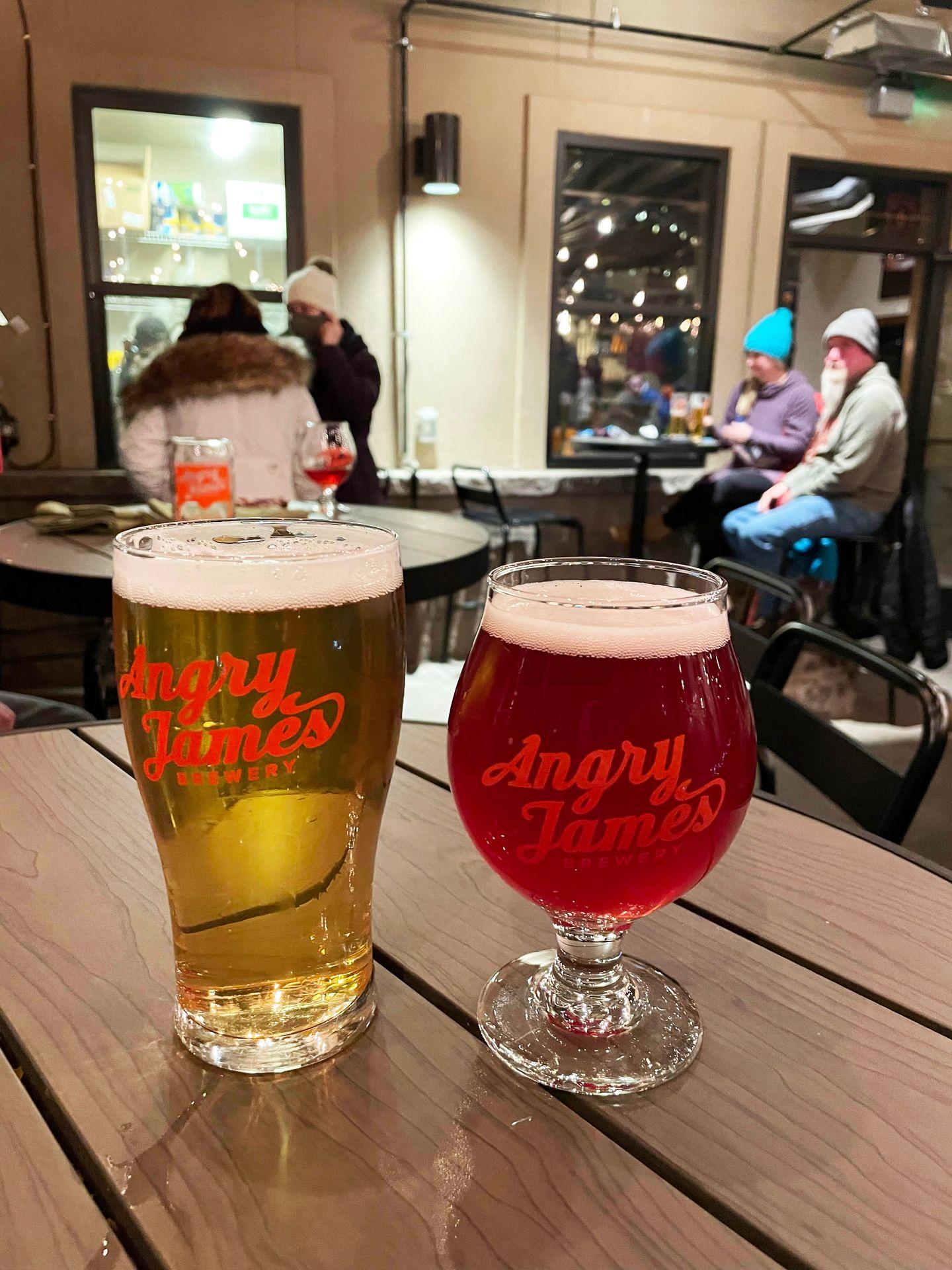 Two glasses of beer on a barrel in Angry James brewery.